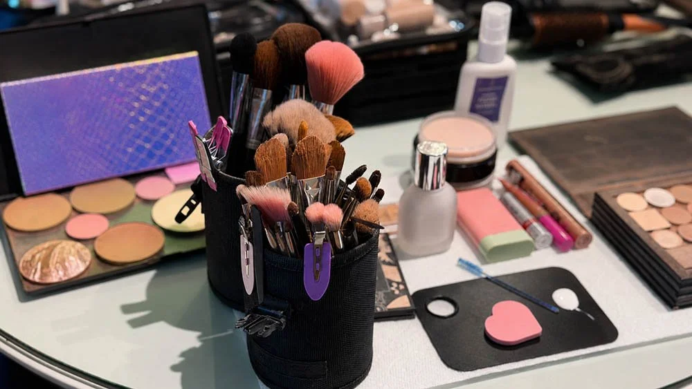 Close-up of makeup brushes in a kit on a professional makeup artist's table