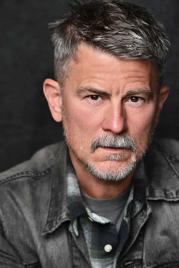 A dramatic, cinematic male actor headshot with a gritty, theatrical look, taken by Los Angeles and Studio City photographer Marc Cartwright.