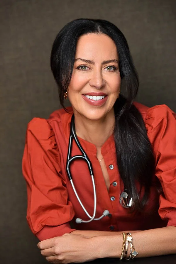 Corporate Photography, Executive Portraits and Business Headshots Los Angeles - This contemporary headshot captures a poised and approachable female medical professional, styled in a rust-colored blouse with puffed sleeves and accessorized with a ste