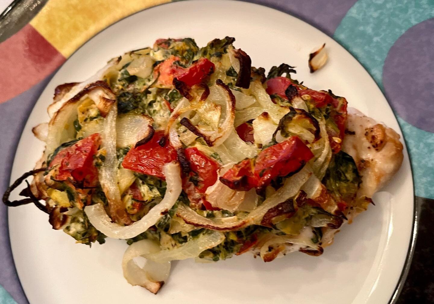 The topping on this grilled chicken is so versatile.  You can use it on any protein, on top of zucchini slices or as a warm dip.  It is made with light cream cheese, spinach, artichokes, tomatoes and mixed Italian cheeses.  Top it with sliced onions 