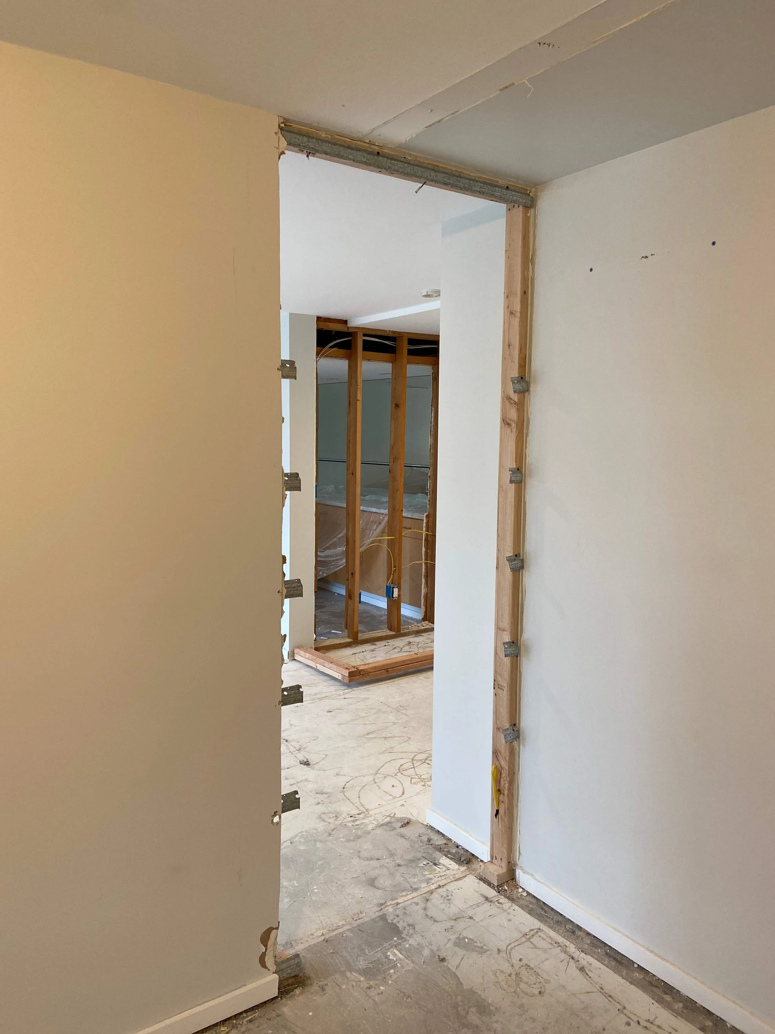 Before drywall repair in Mercer Island WA showing wall opening cut for remodel with exposed framing and unfinished edges.