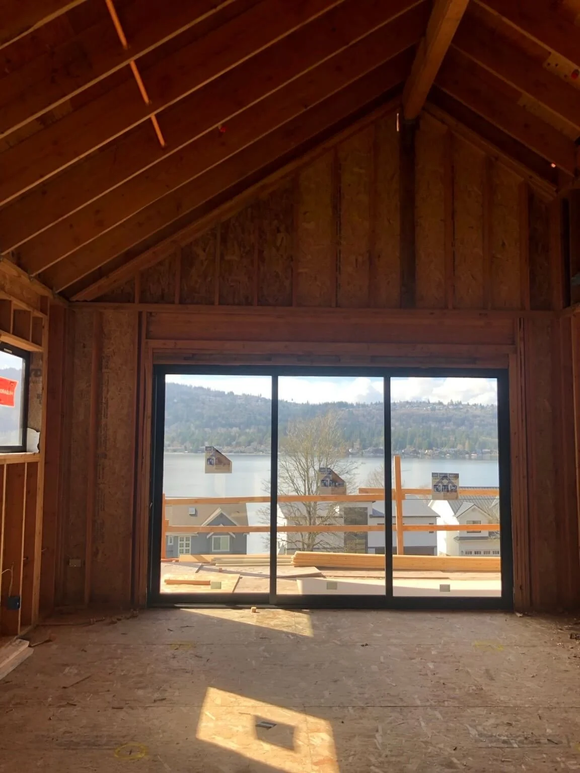 Bellevue whole-home remodel before drywall installation and Level 5 smooth-wall finishing around large windows