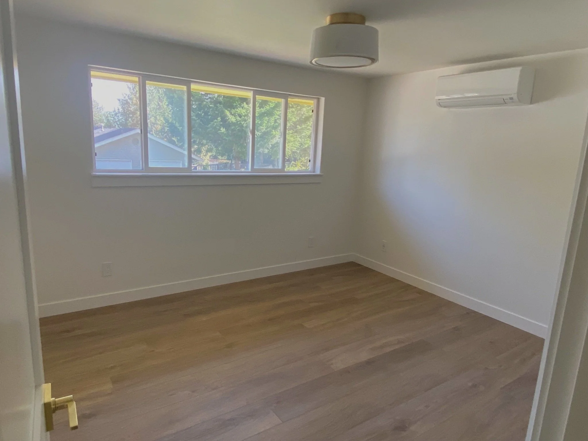 Smooth skim-coated drywall walls replacing textured finish in modern home interior