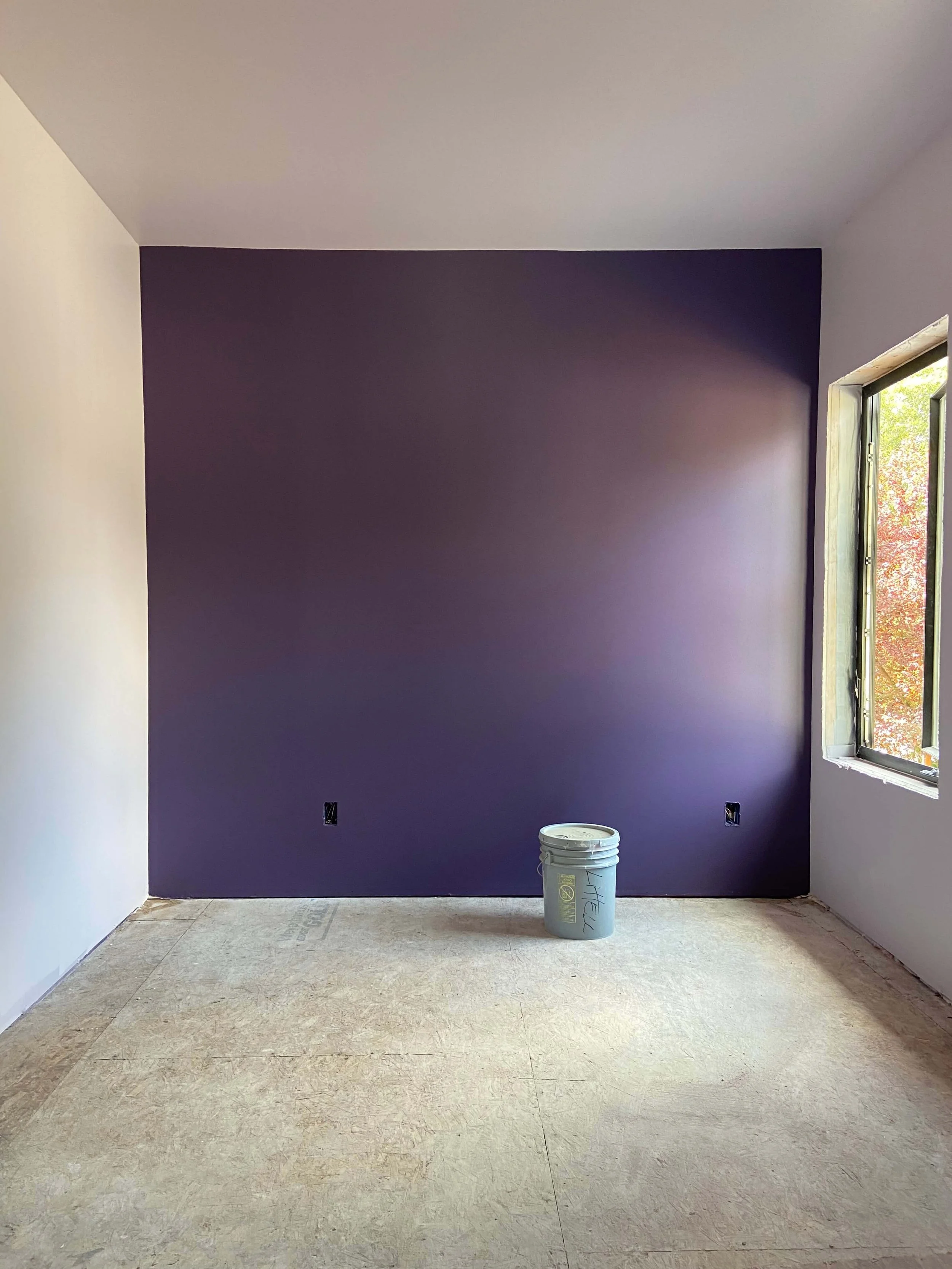 Alt text Seattle custom home room after drywall installation, Level 4 finishing, PVA primer, and interior painting with a purple accent wall
