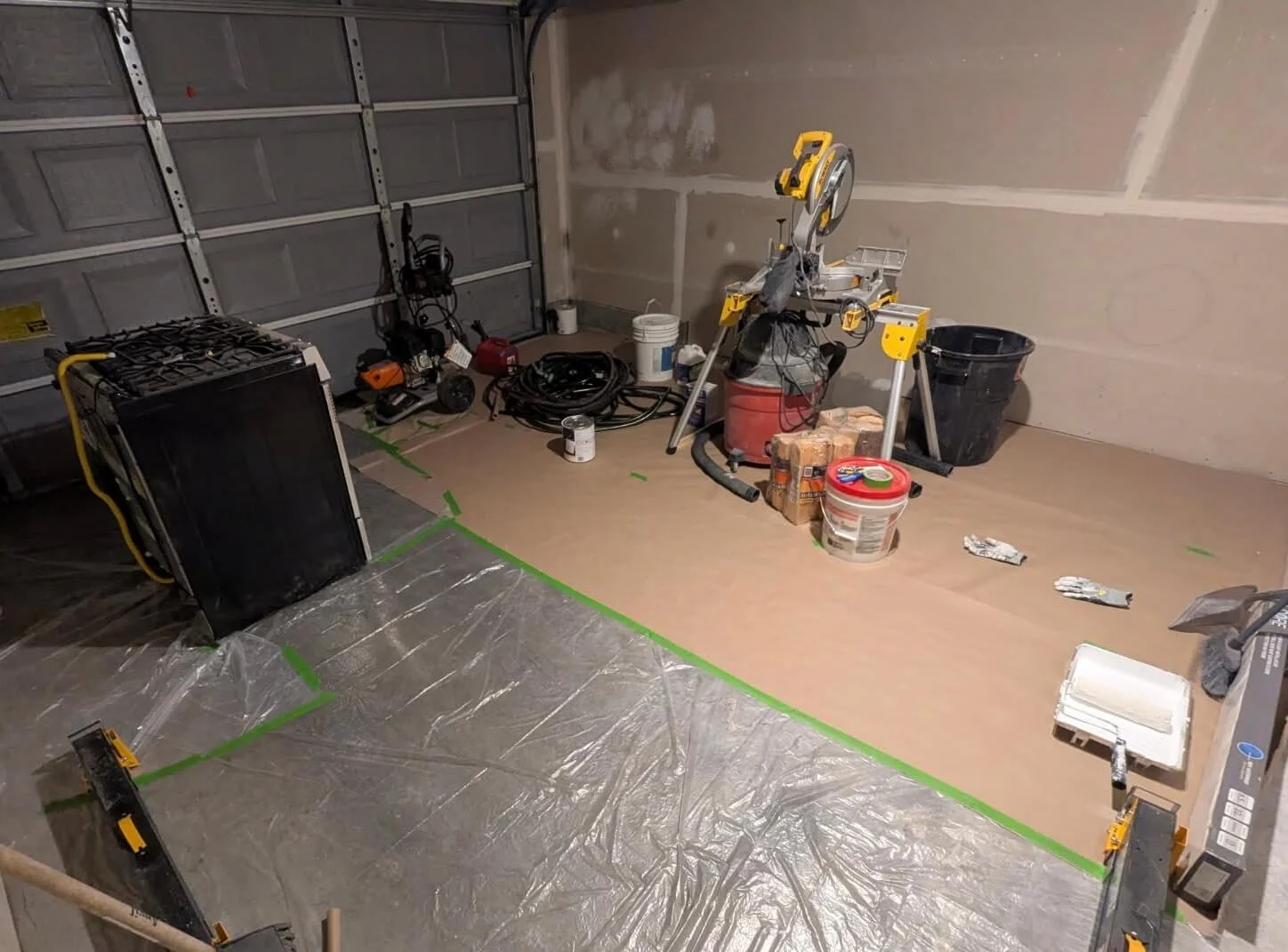 Builder-grade Level 2 garage drywall before refinishing in Seattle WA showing visible drywall seams, tape joints, and unfinished wall surfaces.