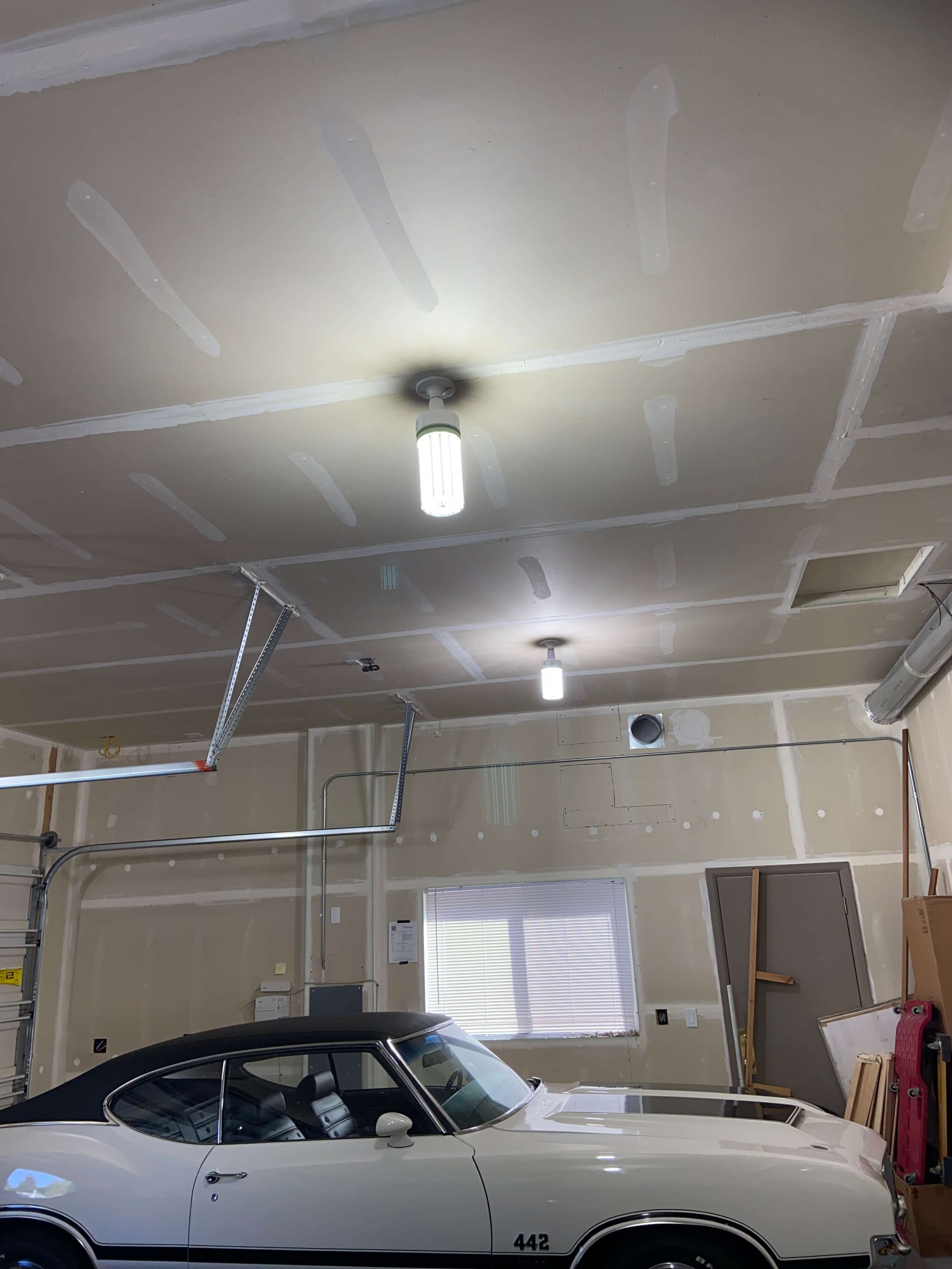 Builder-grade garage wall and ceiling evaluation before drywall finishing and painting in Bothell WA.
