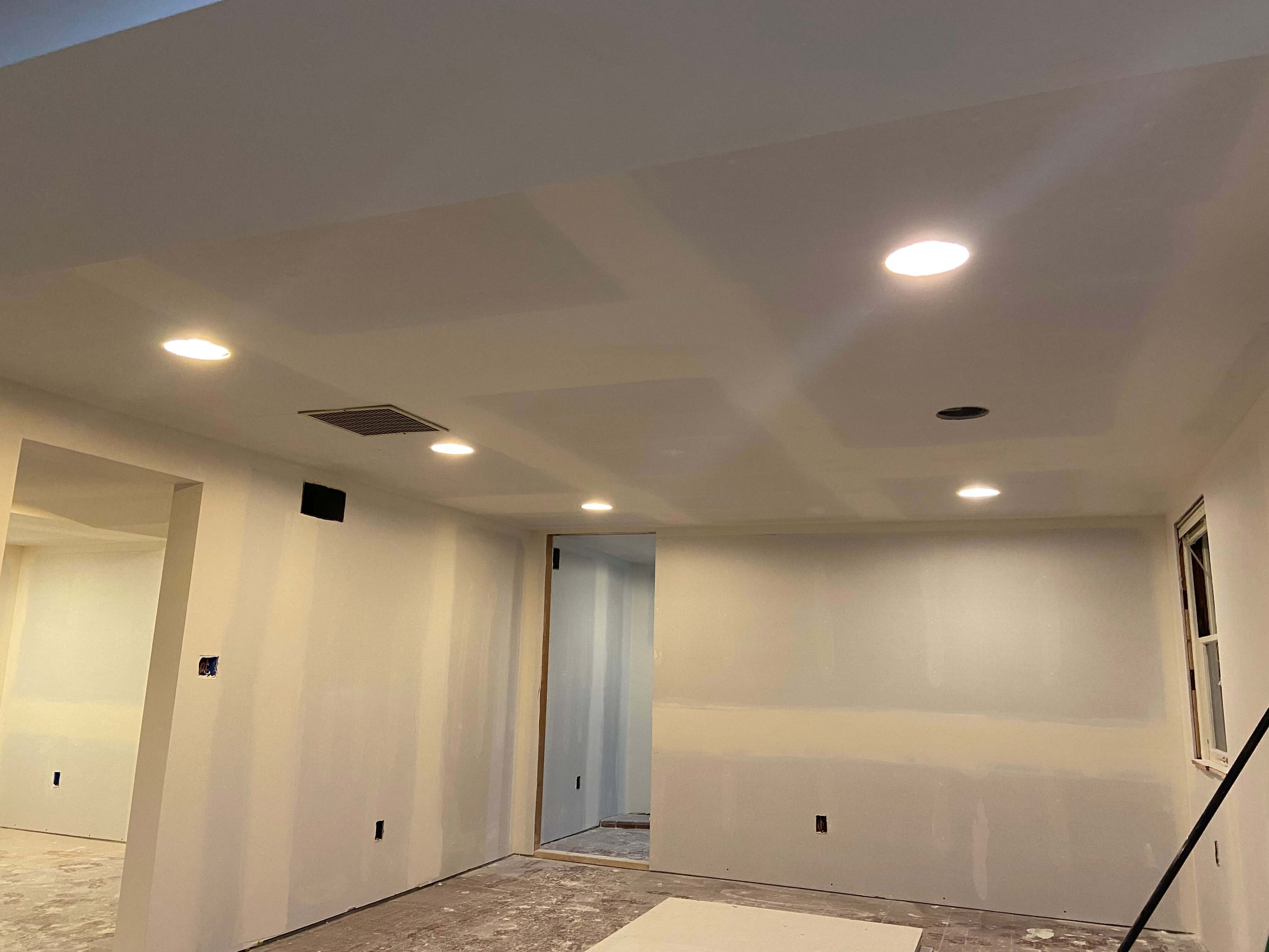 Drywall finishing in progress on basement walls and ceiling in Seattle's Magnolia neighborhood.