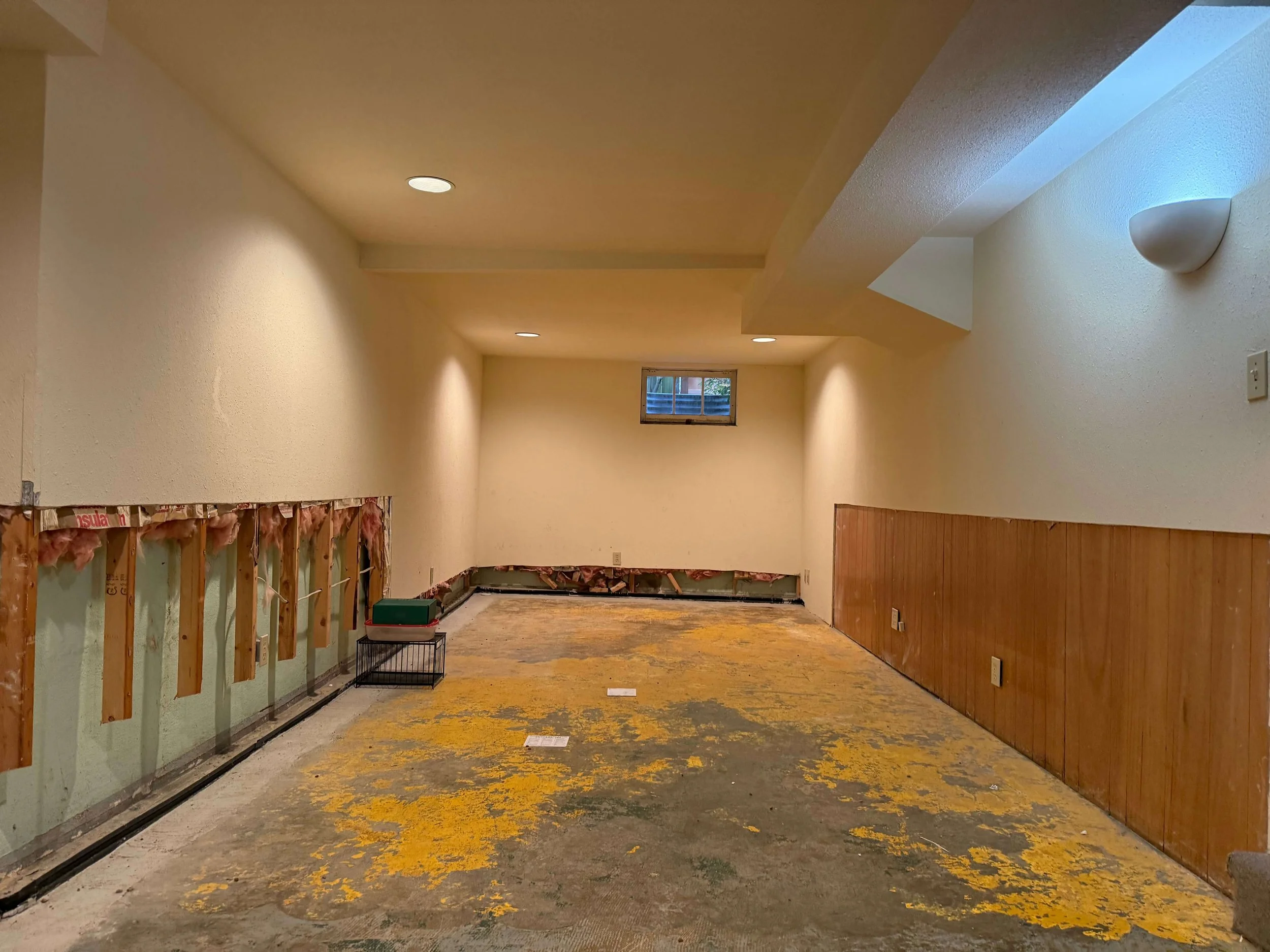 Queen Anne basement in Seattle before drywall repair and skim coating with lower wall sections removed