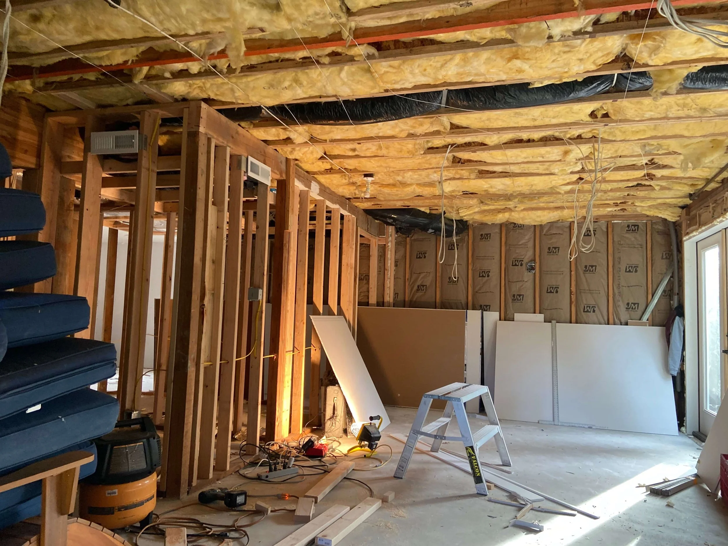 Wall and ceiling insulation installed in an unfinished Lynnwood basement before drywall.