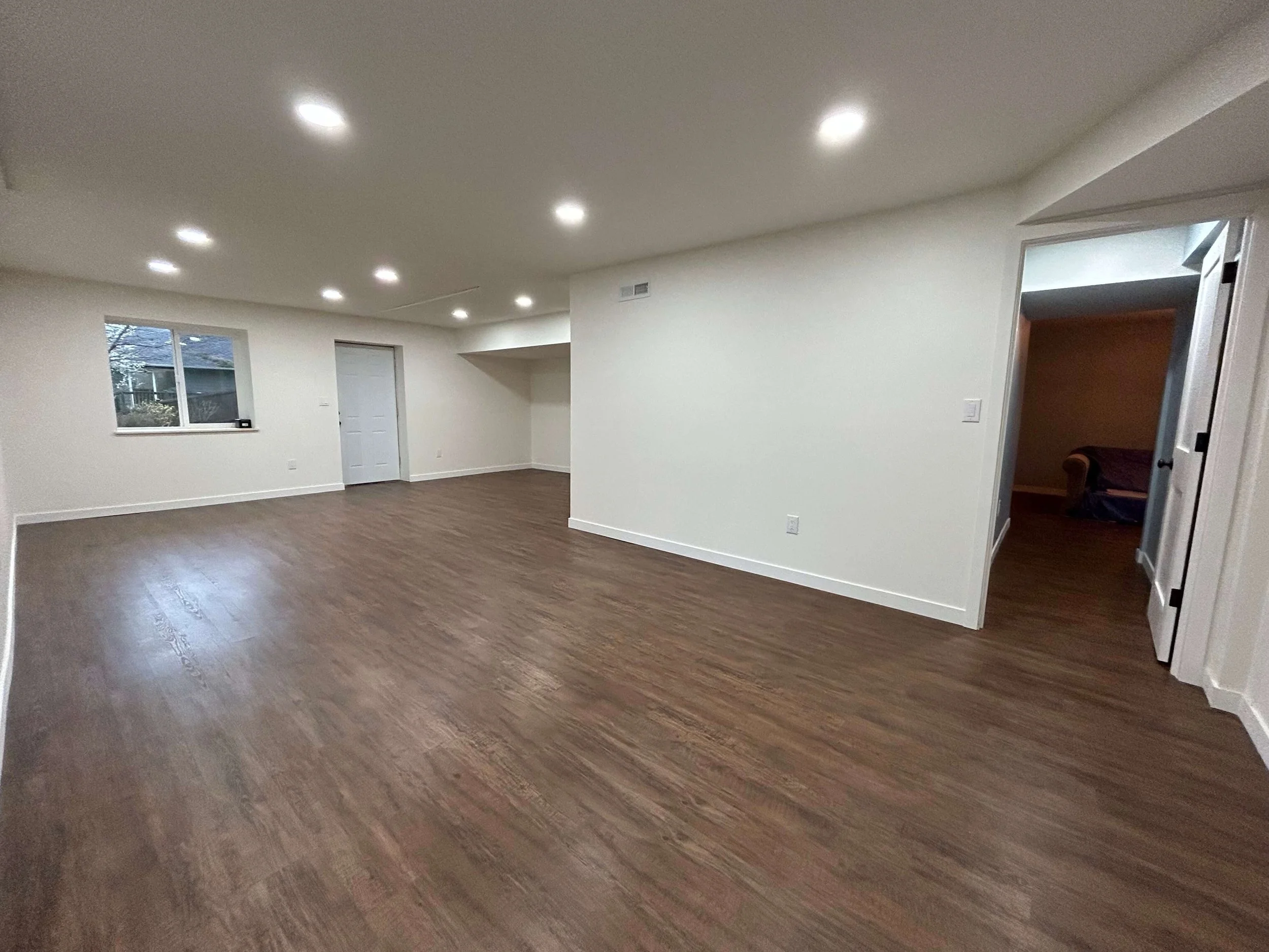 Completed basement drywall installation with smooth, painted walls and ceilings in Lynnwood, WA.