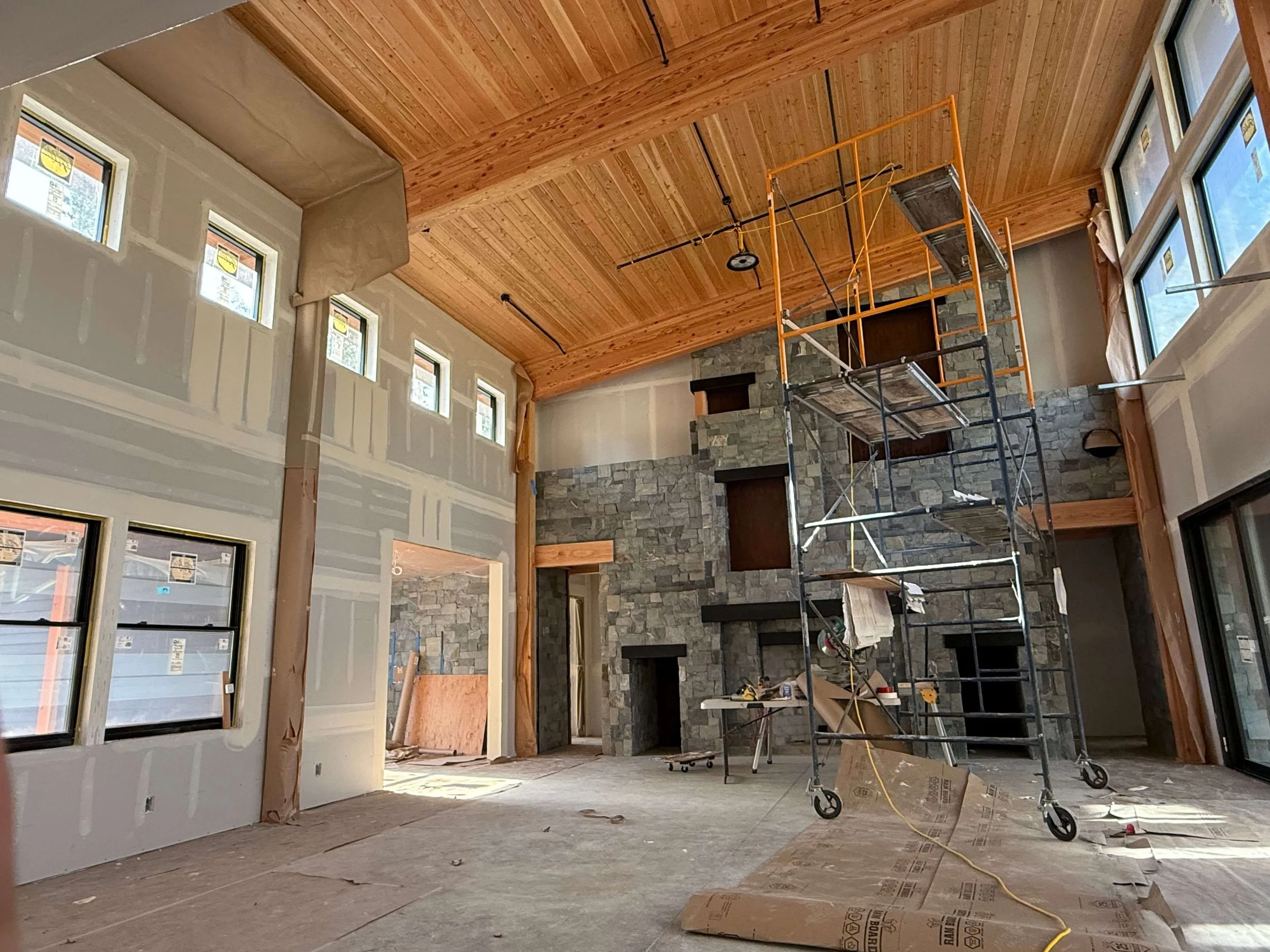 Duvall custom home during Level 4 and Level 5 drywall finishing around vaulted ceilings and exposed wood details