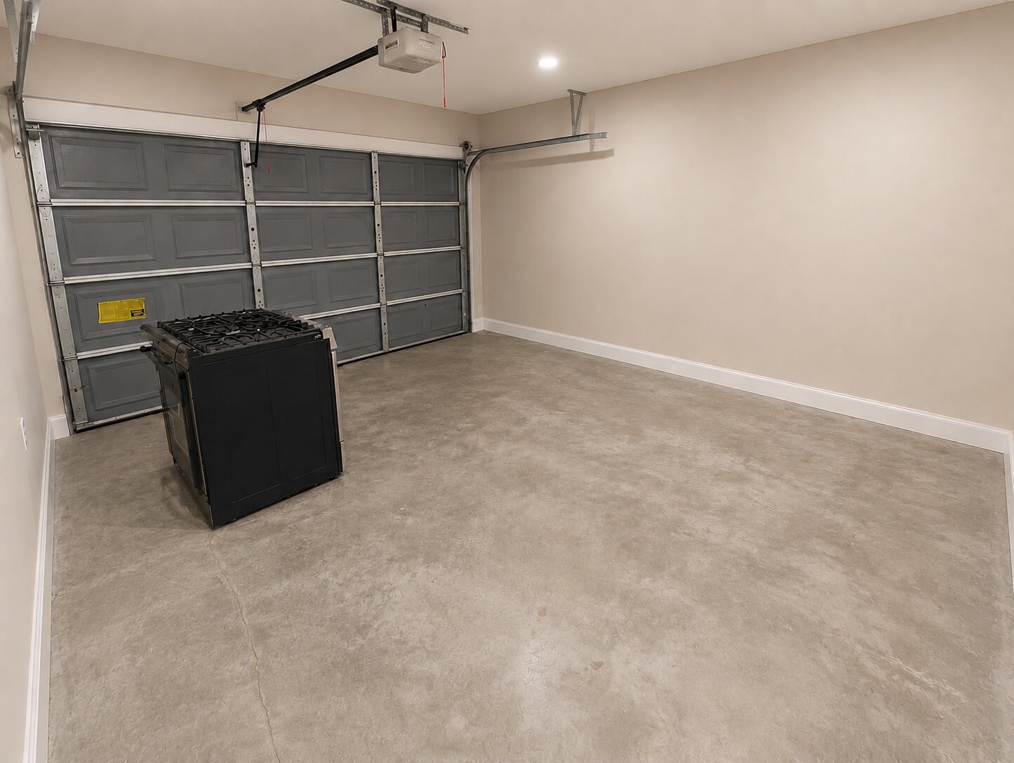 Finished garage with Level 4 drywall, smooth painted walls, recessed lighting, and concrete flooring in Seattle, WA