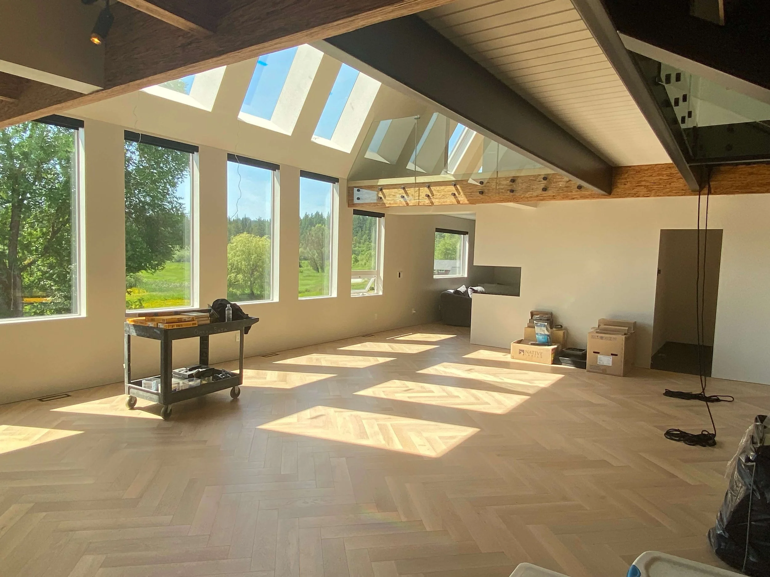 Finished Redmond, WA whole-home remodel with Level 5 smooth drywall, vaulted ceilings, skylights, exposed beams, and herringbone flooring