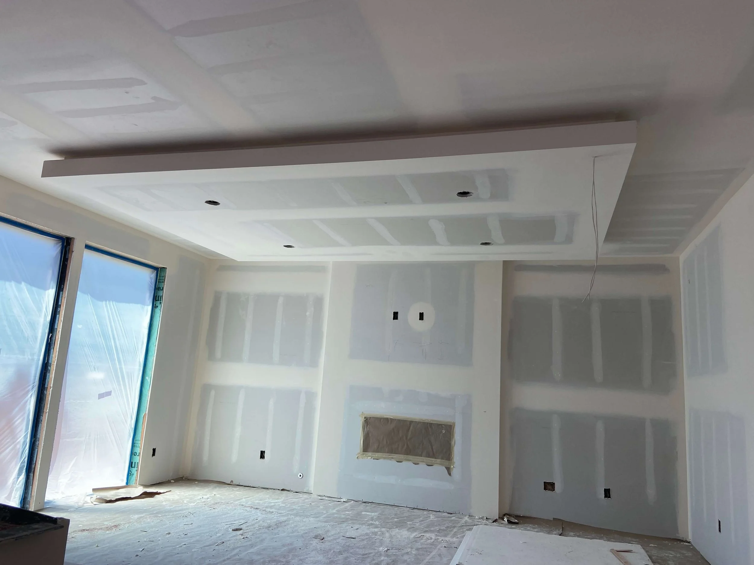 Custom home framing with vaulted ceilings before drywall installation in Kenmore, WA.