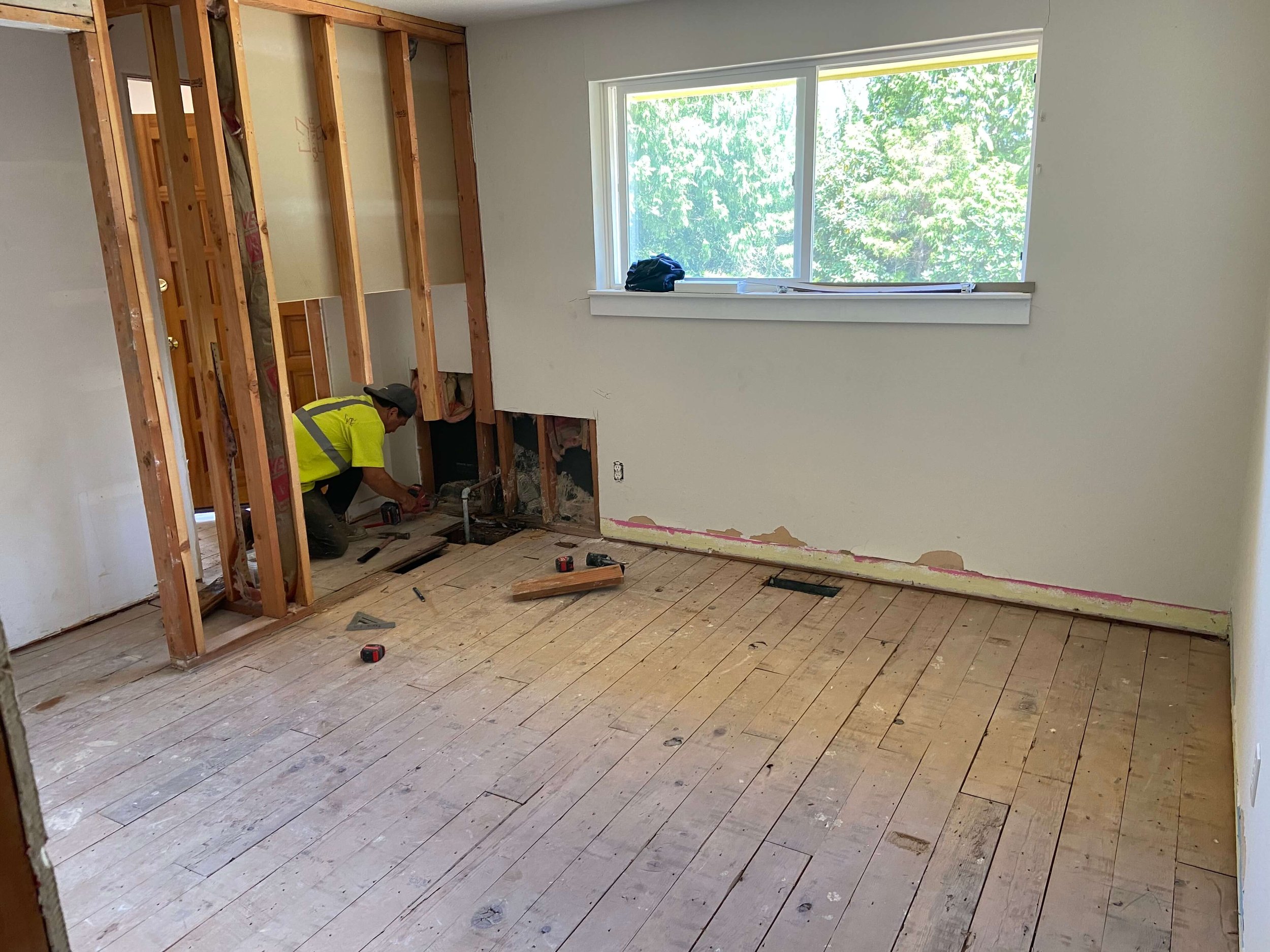 Before drywall installation in a Redmond WA home showing wall demolition with exposed framing prior to skim coating and finishing.