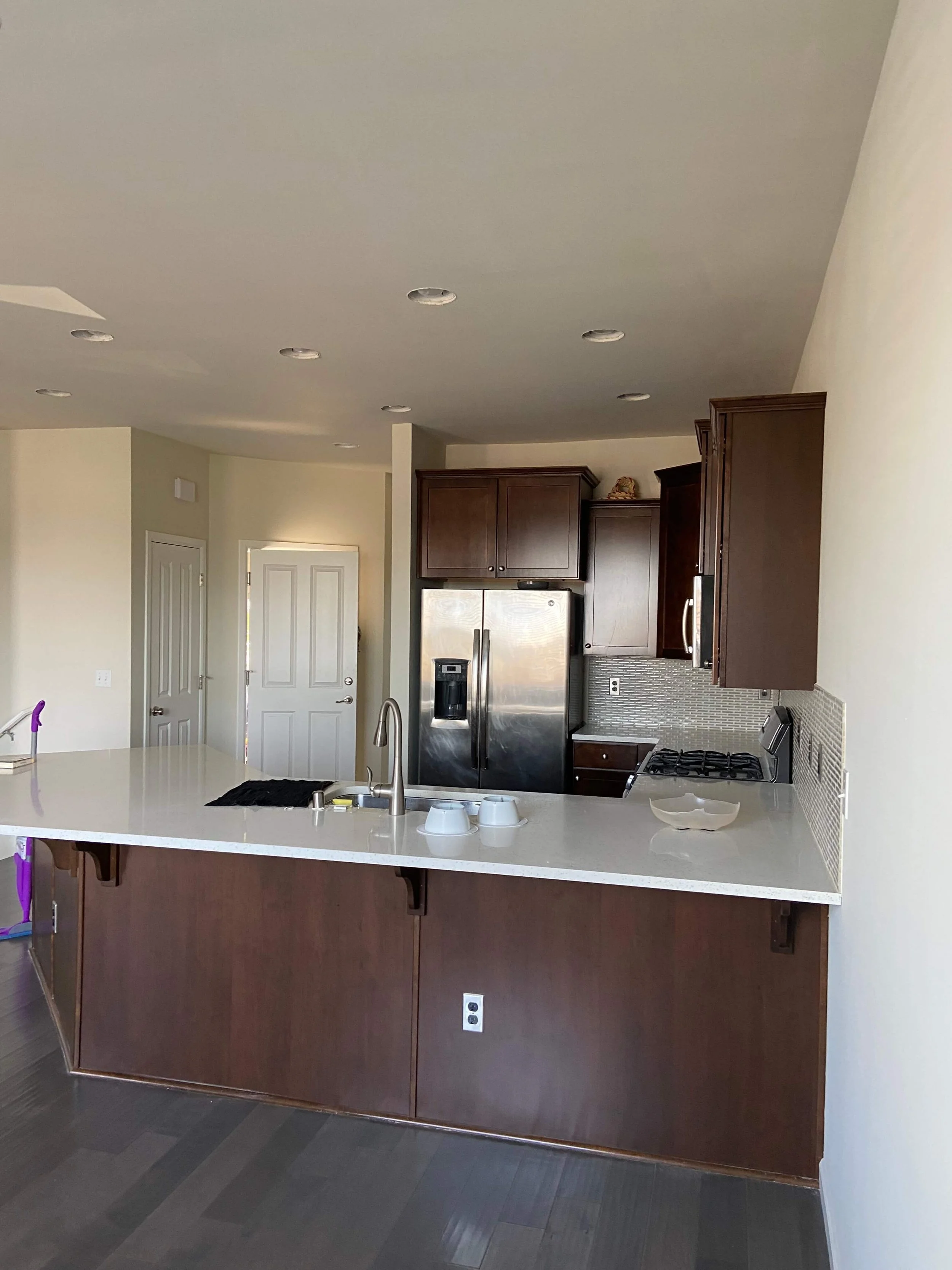 Restored kitchen ceiling with finished and painted drywall above the cabinets and island in Lynnwood, WA.