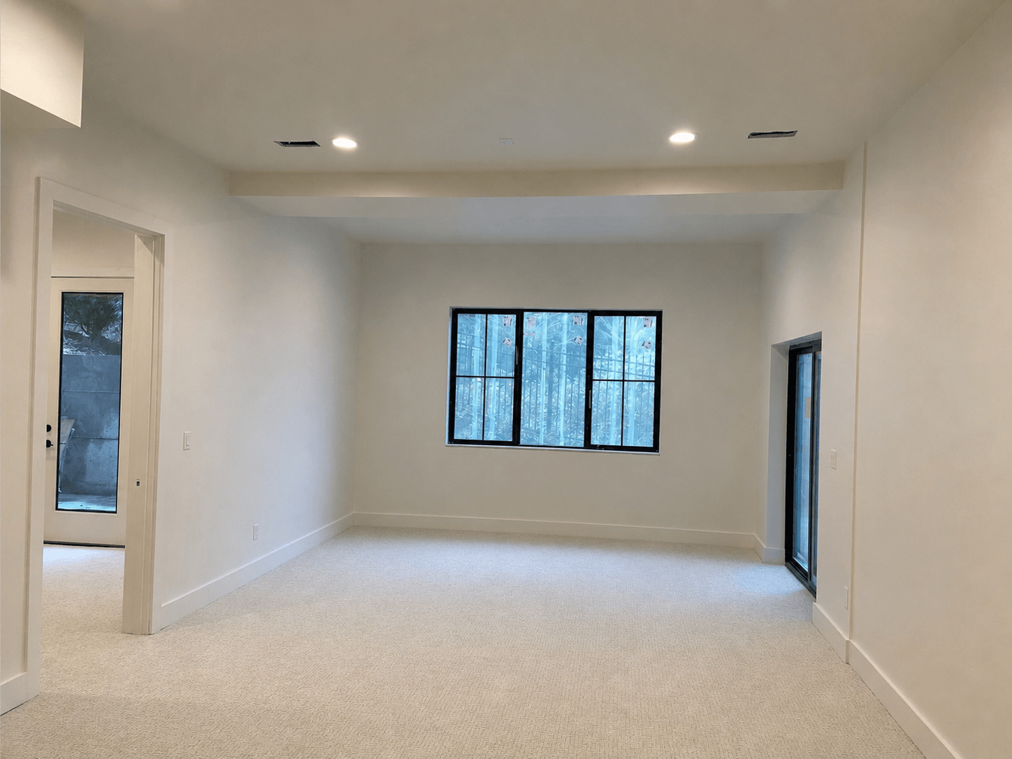 Completed Snohomish interior with Level 4 drywall, neutral painted walls, white ceiling, recessed lighting, and carpet.