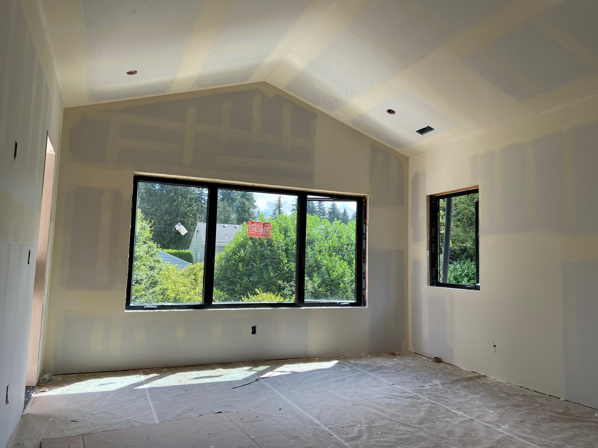 Before drywall installation project in North Seattle showing unfinished walls prior to finishing and painting