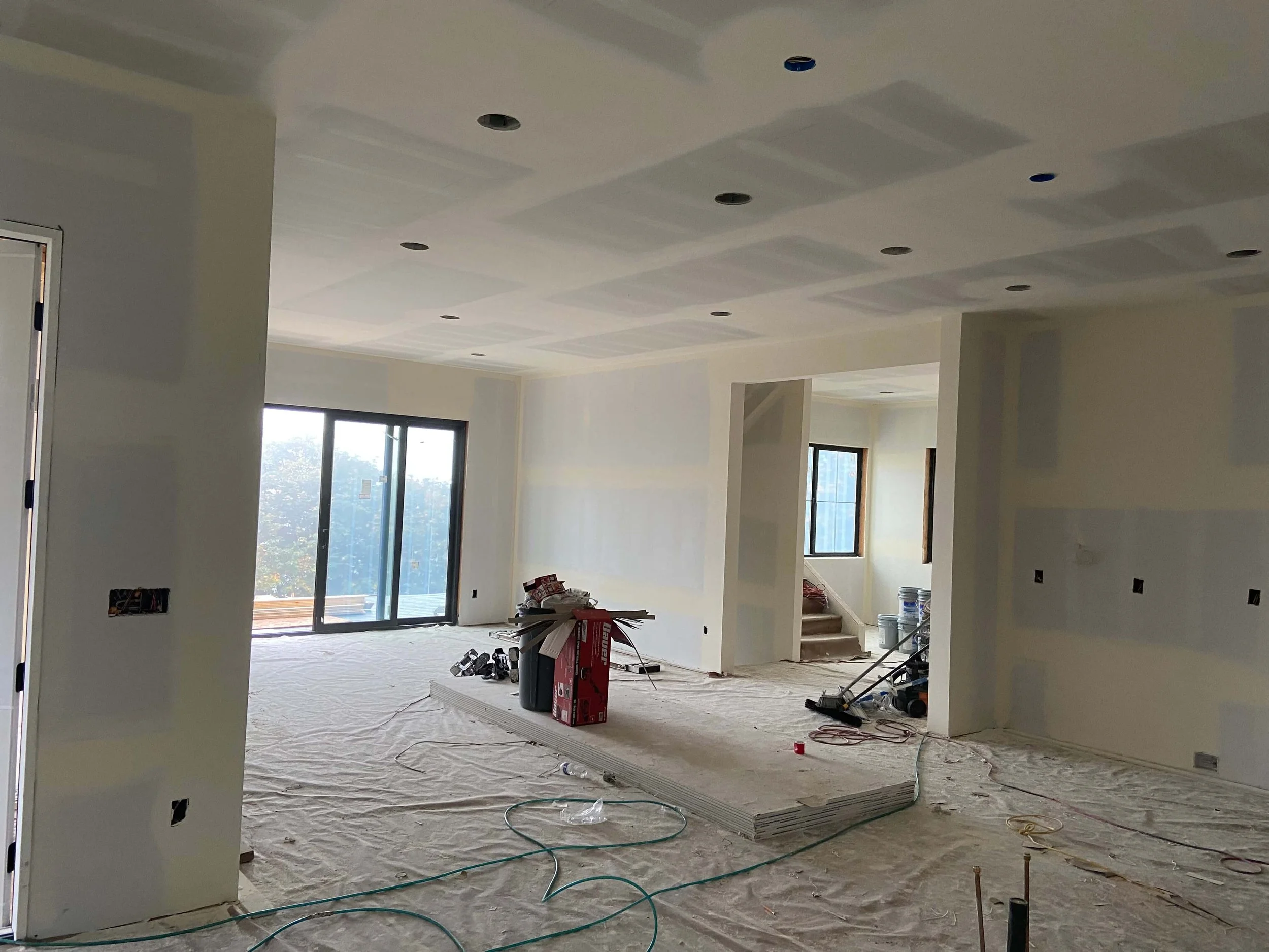 Detailed drywall sanding and surface inspection for smooth wall finishing in Issaquah, WA