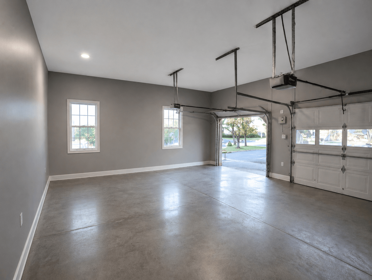 Professionally finished garage with smooth drywall, interior paint, upgraded lighting, and clean concrete floors in Kirkland, WA