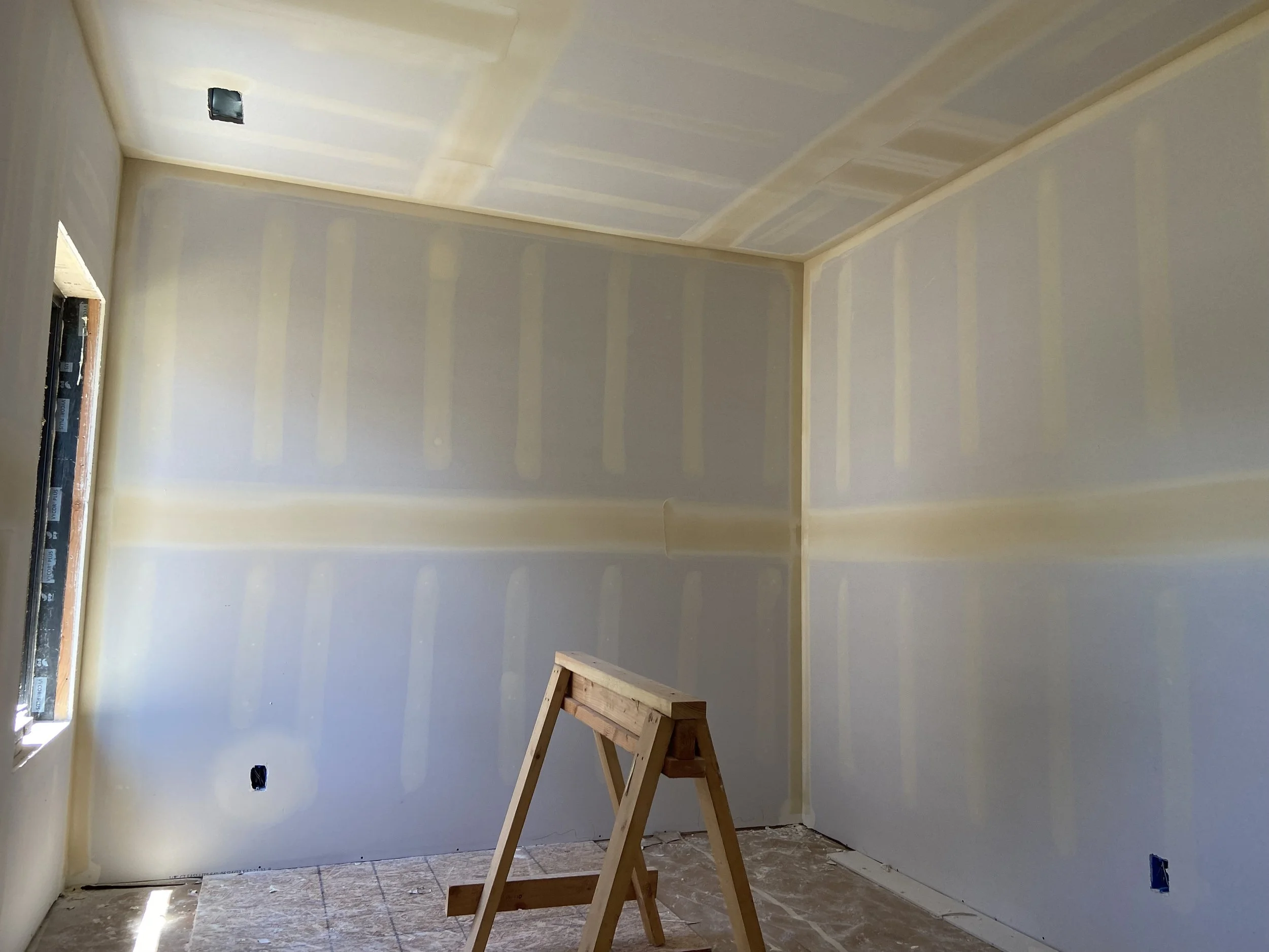 Unfinished Seattle basement before drywall installation with exposed framing and open construction