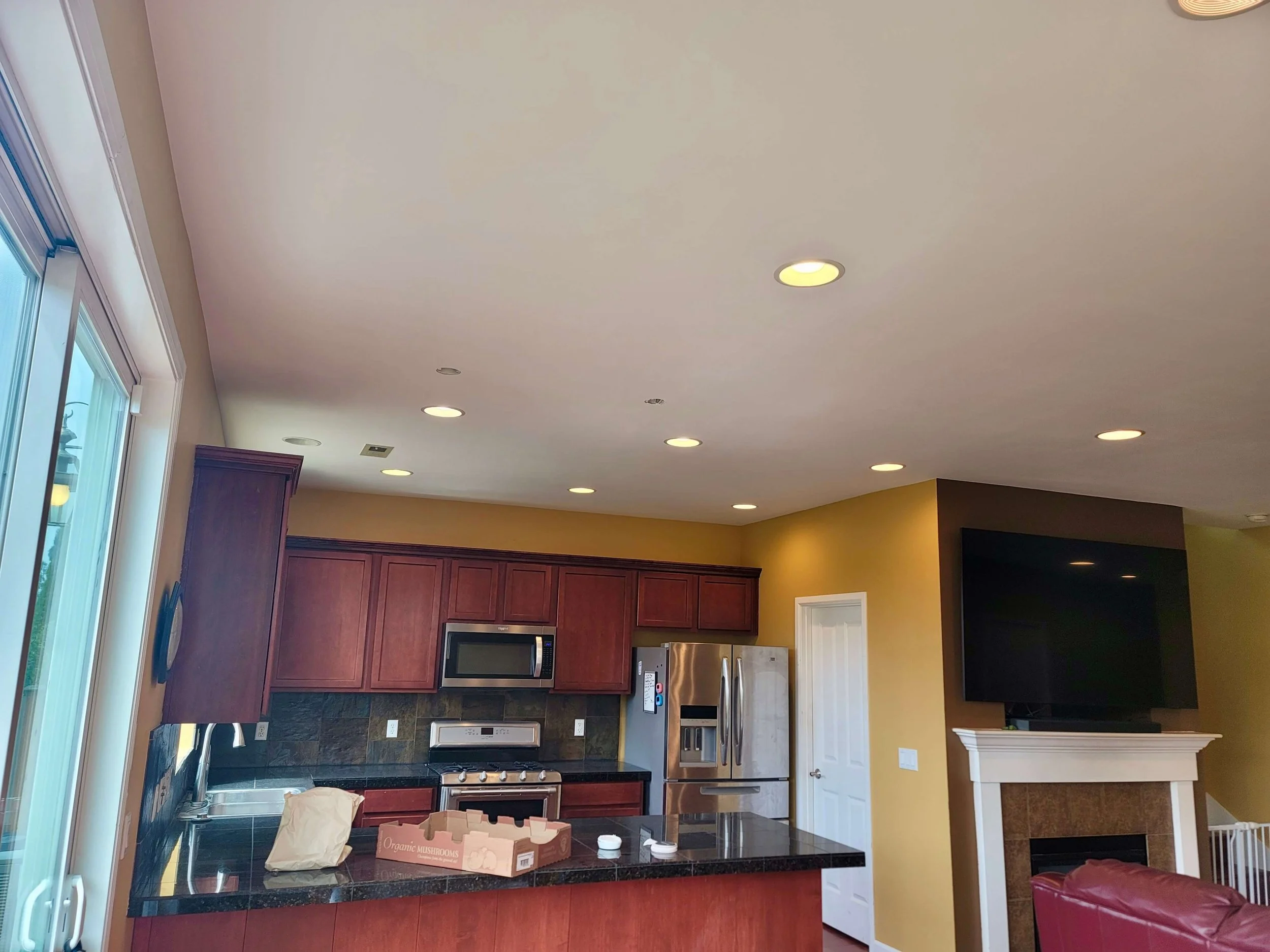 After drywall installation in a Lynnwood WA home with a new ceiling, Level 4 smooth finish, recessed lighting, and professional interior painting.