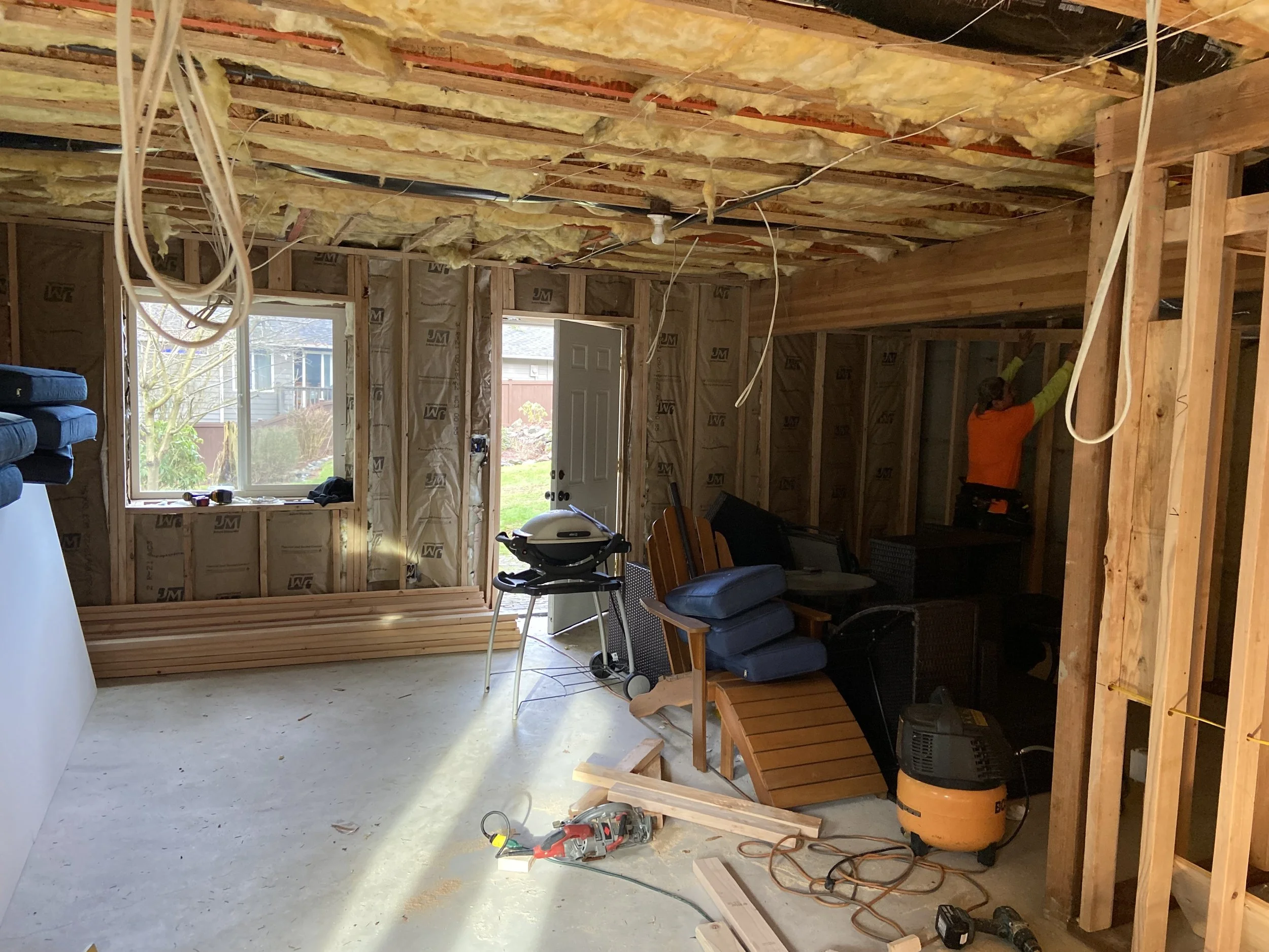 Unfinished basement in Lynnwood before drywall installation with exposed framing and open wall cavities