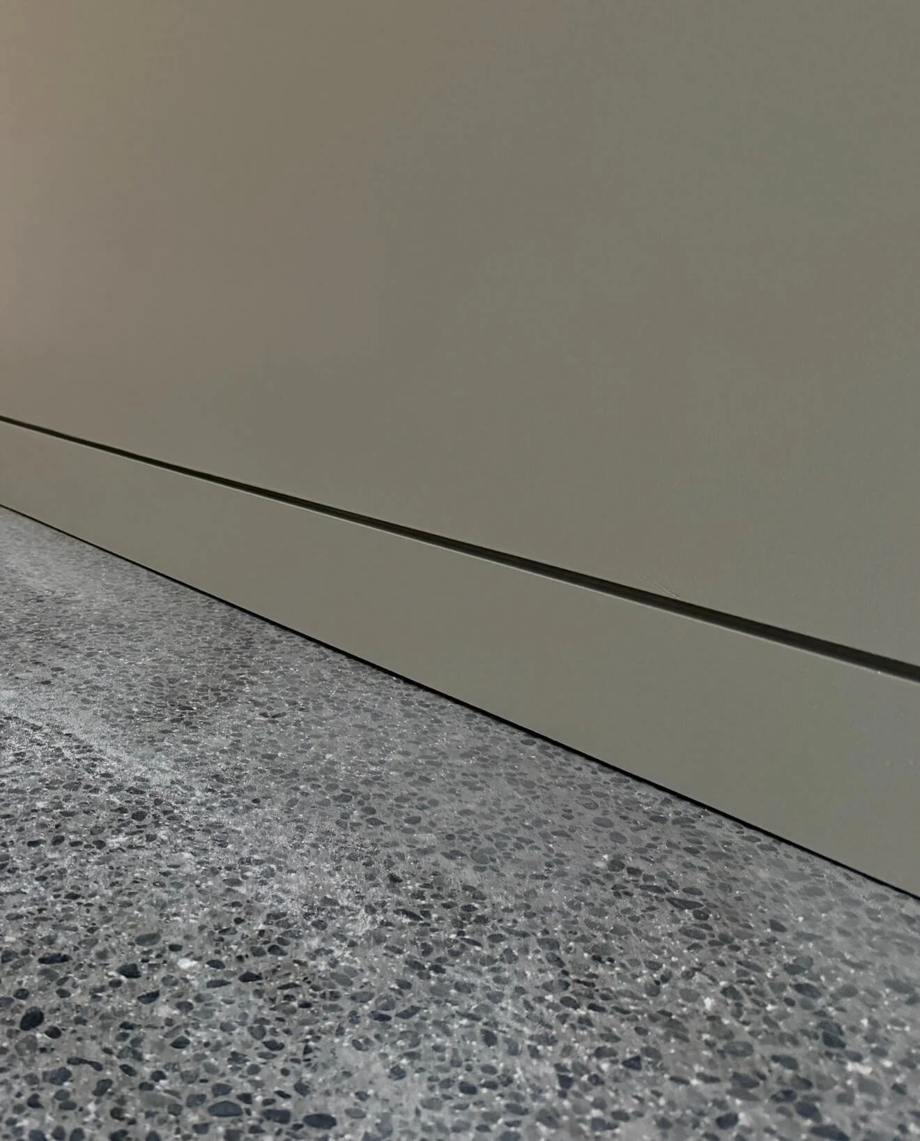 Architectural drywall detail in Redmond featuring recessed baseboards, flush doors, and shadow reveal transitions