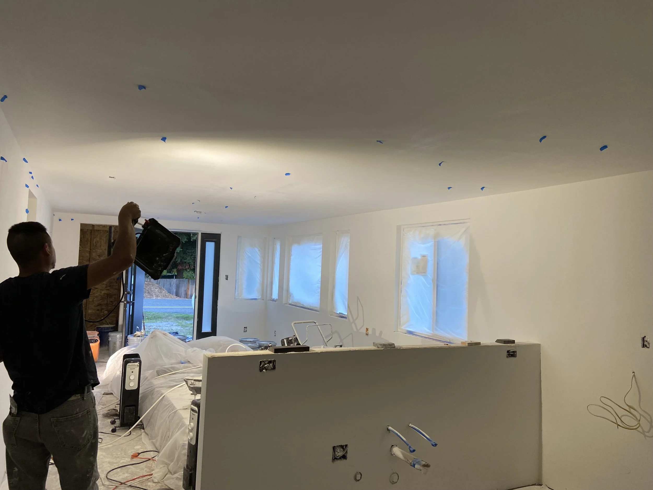 Applying primer and touch-ups for smooth drywall finish in Seattle, Bellevue, and Redmond — L.A. Drywall Inc.