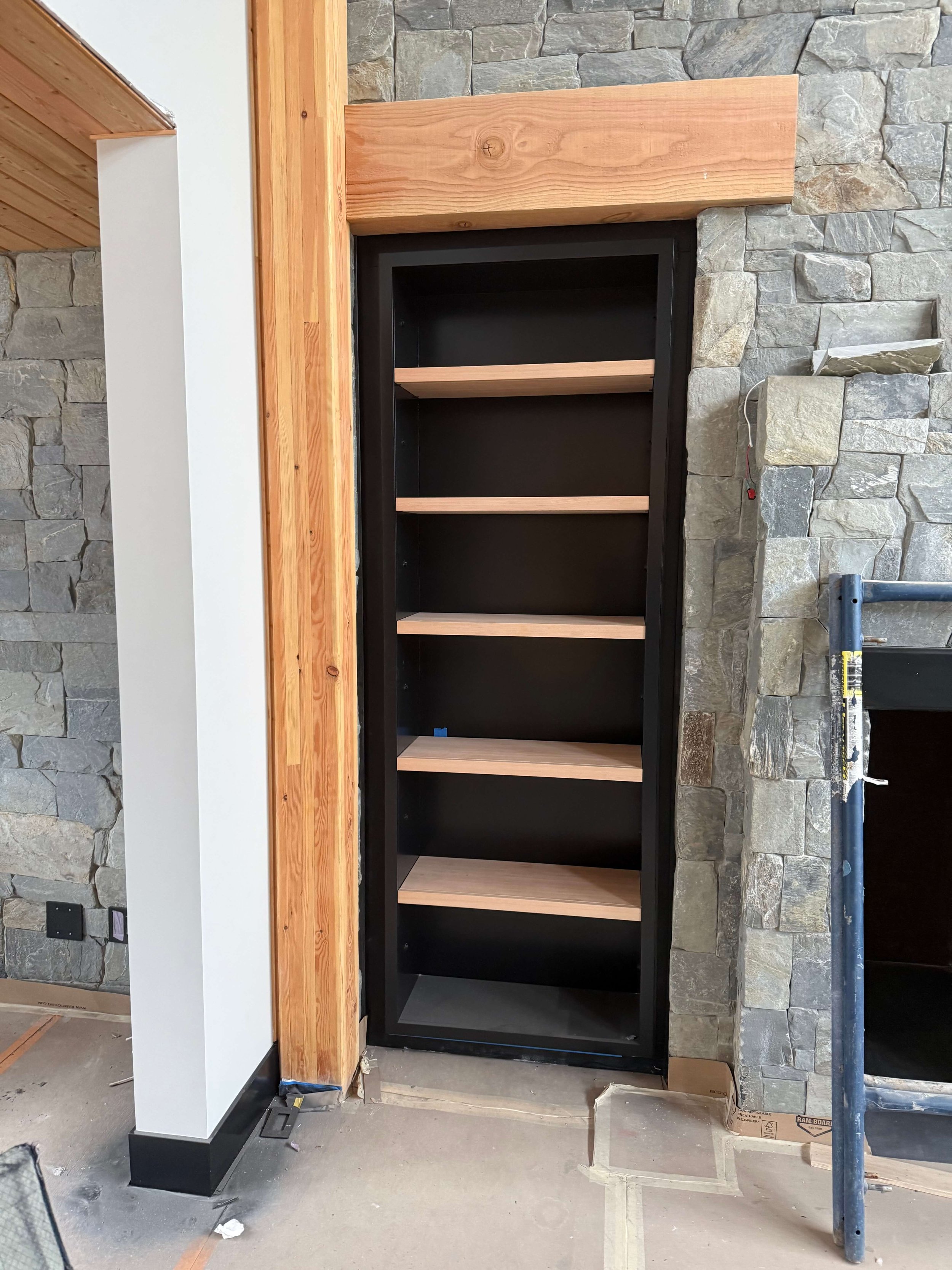 Spray-finished millwork, trim, and built-in shelving completed in a custom Duvall home