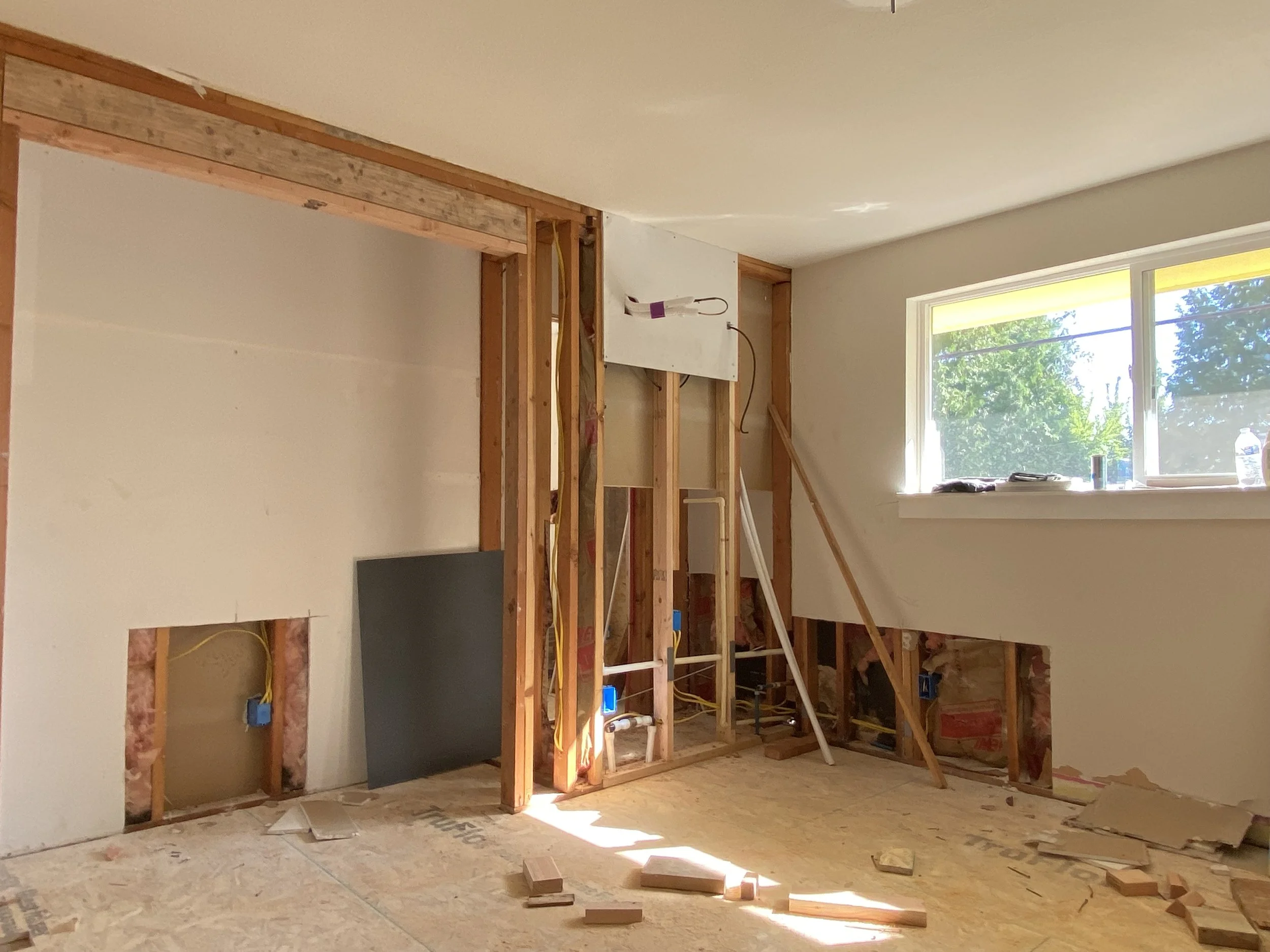 Before drywall repair in Redmond WA showing wall openings and unfinished drywall.