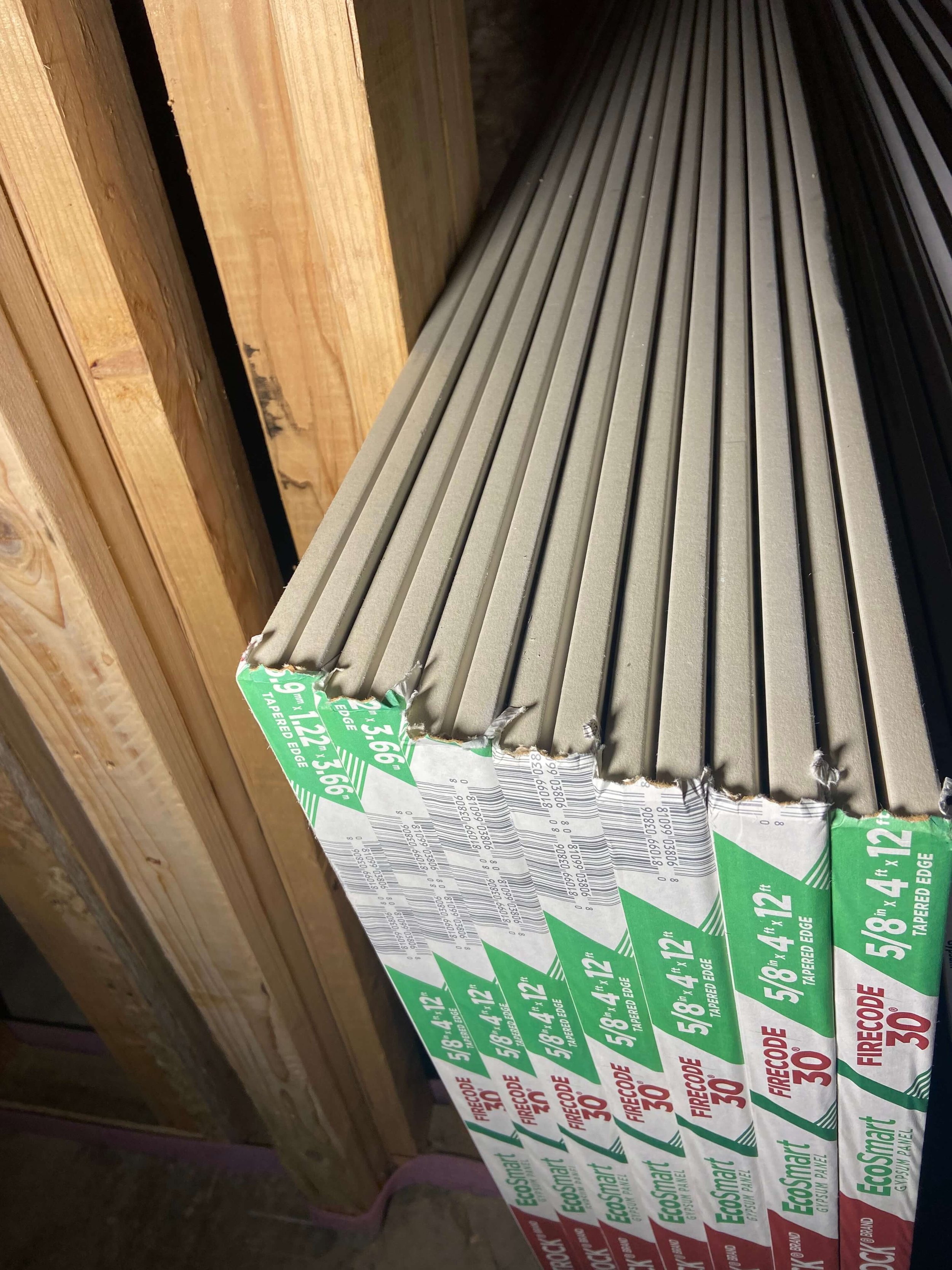 Drywall delivery and stocking in a Seattle WA project with 5/8 inch sheets staged for efficient installation and minimal handling.
