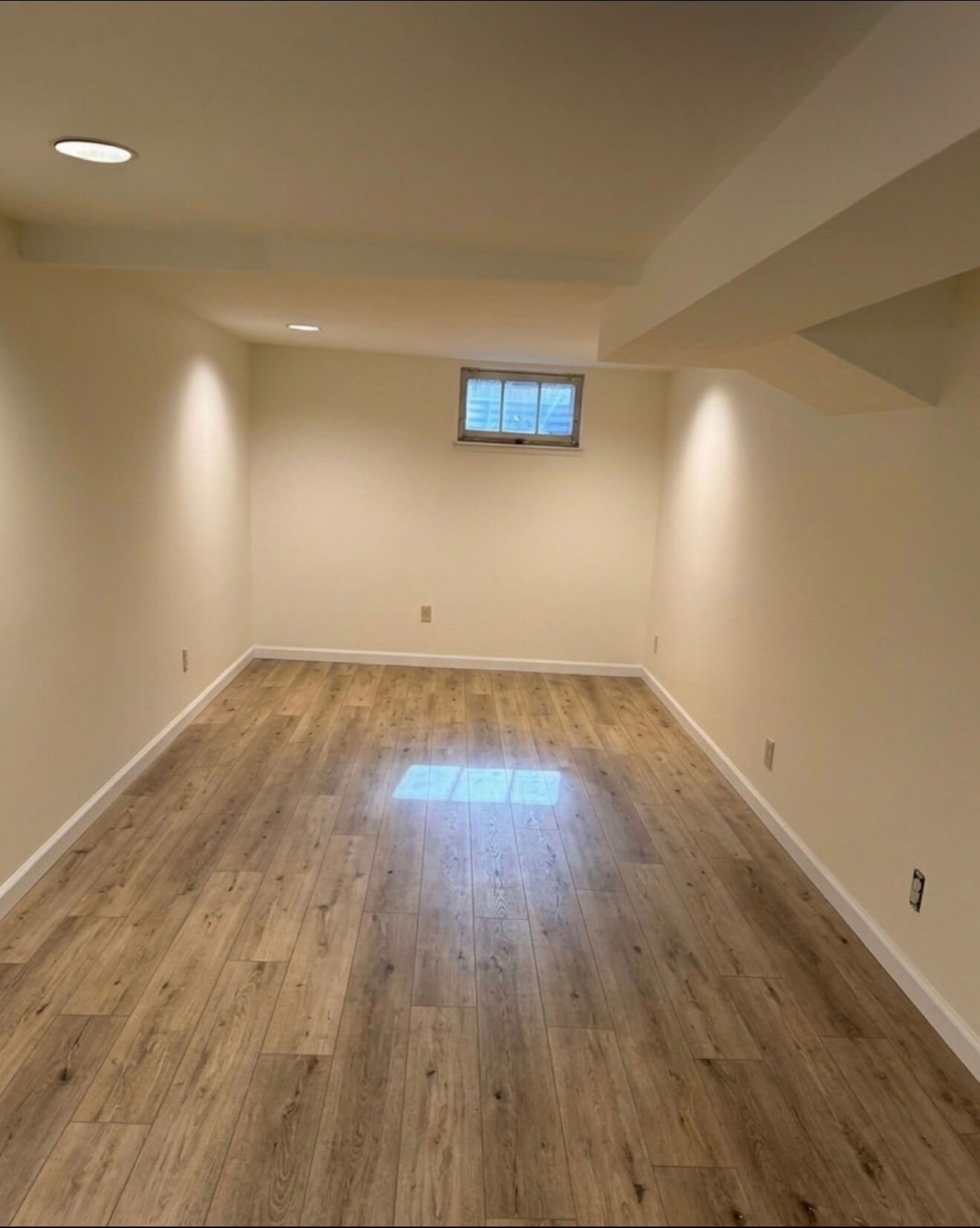 Finished Queen Anne basement after drywall repair, skim coating, and interior painting in Seattle, WA