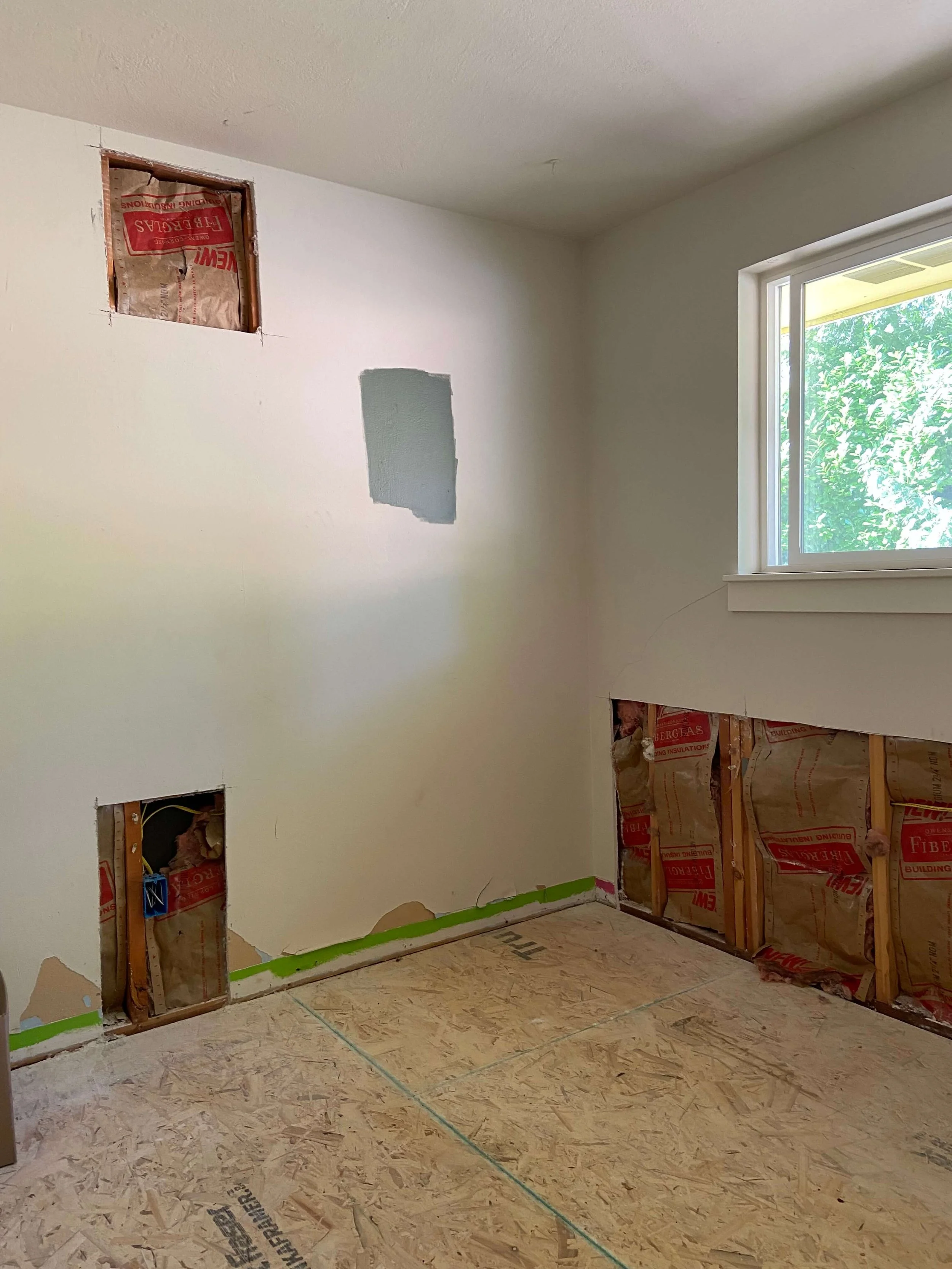 Redmond bedroom with opened lower wall sections and previous patches before drywall repair, skim coating and painting.