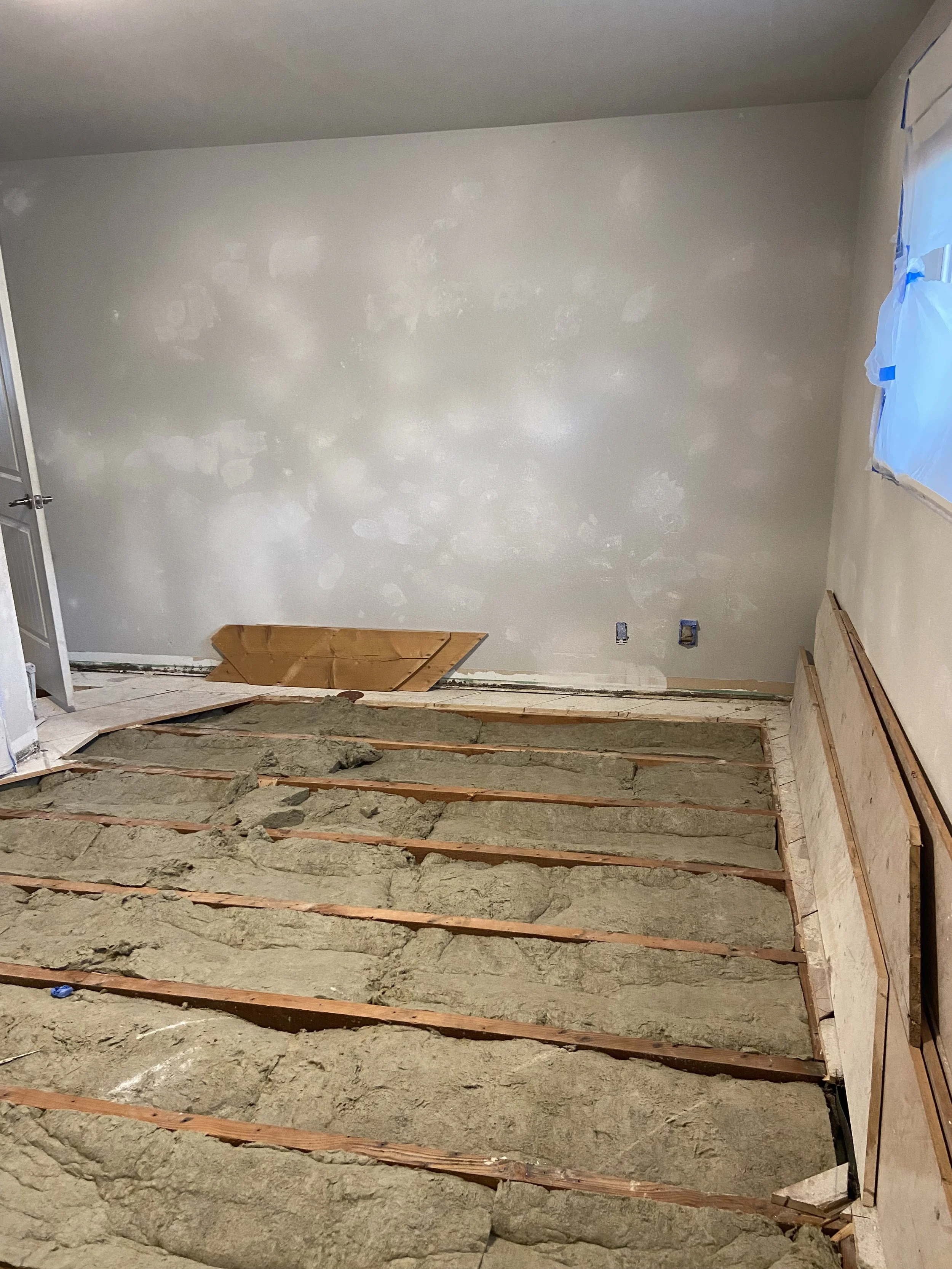 Before drywall repair in Bothell WA showing damaged walls and exposed subfloor.