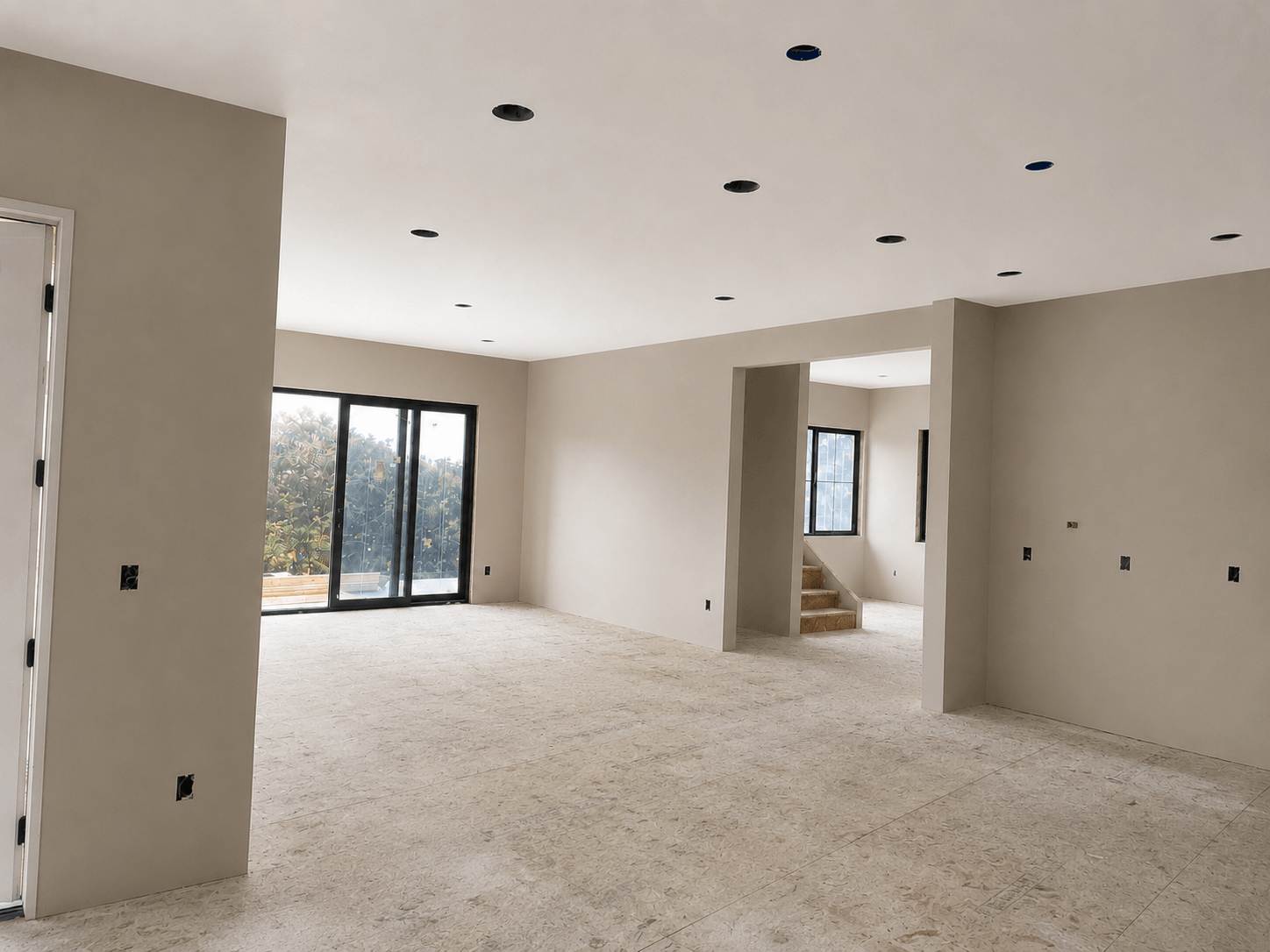 Finished Snohomish custom home with Level 4 drywall, neutral painted walls, recessed lighting, large windows, and open layout.