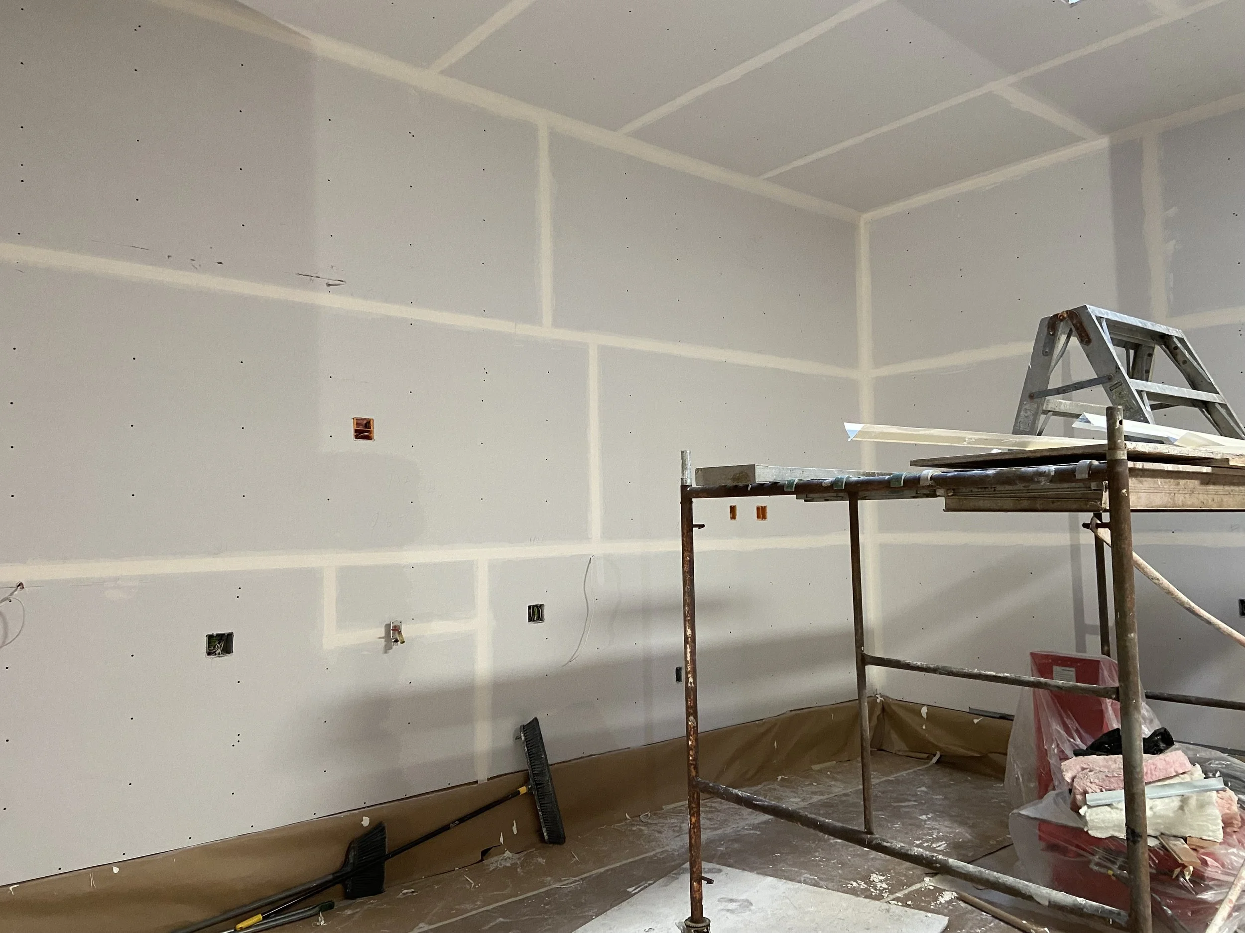Level 1 drywall finish with taped joints and embedded joint compound for fire-taping applications