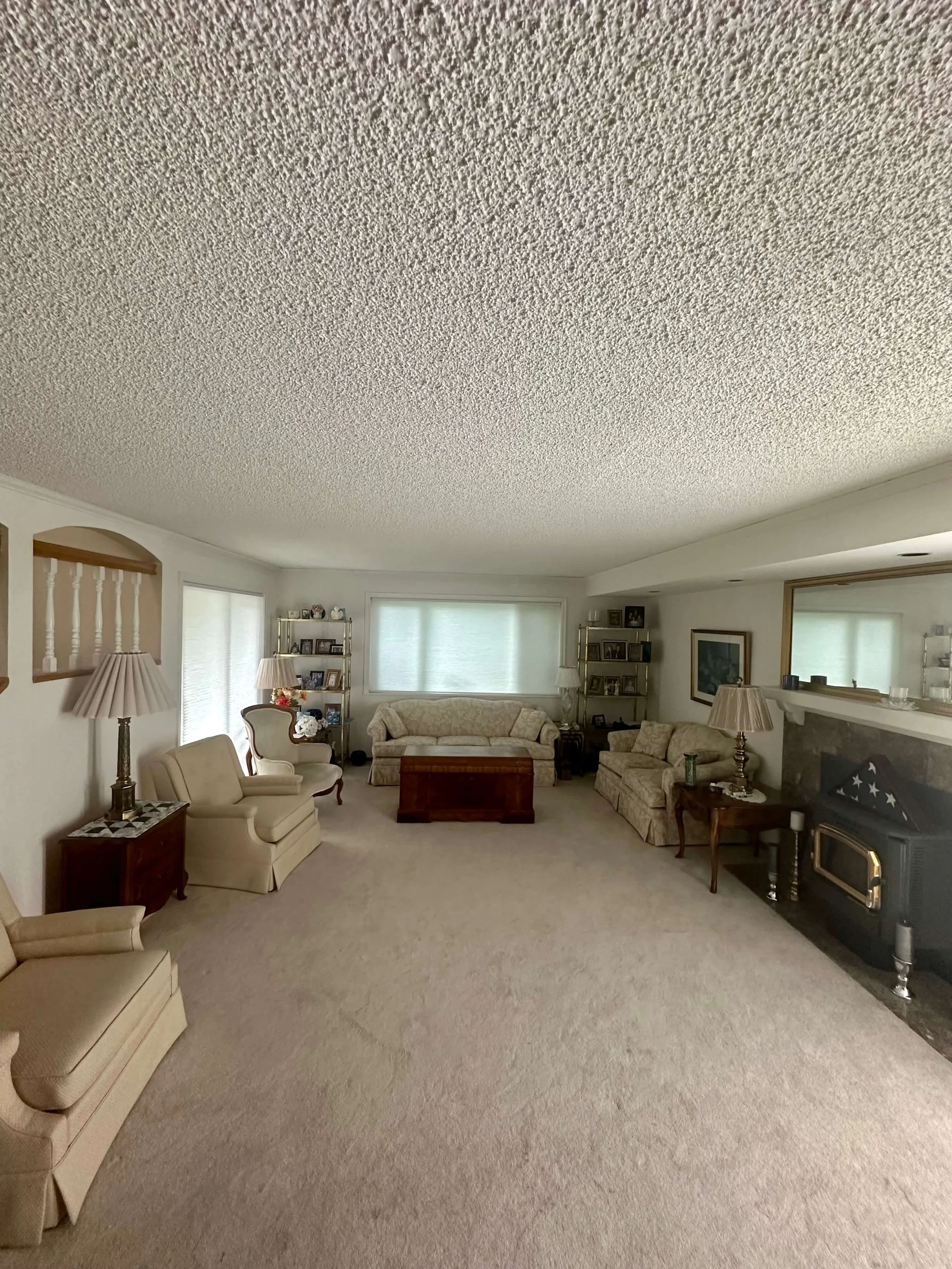 Living room in Bellevue before popcorn ceiling removal, skim coating, and interior refinishing