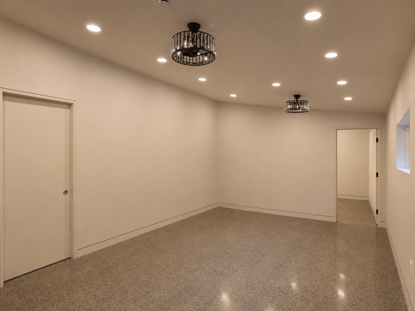Finished Redmond interior with smooth Level 5 walls and ceiling, recessed baseboards, recessed door casings, and polished concrete flooring.
