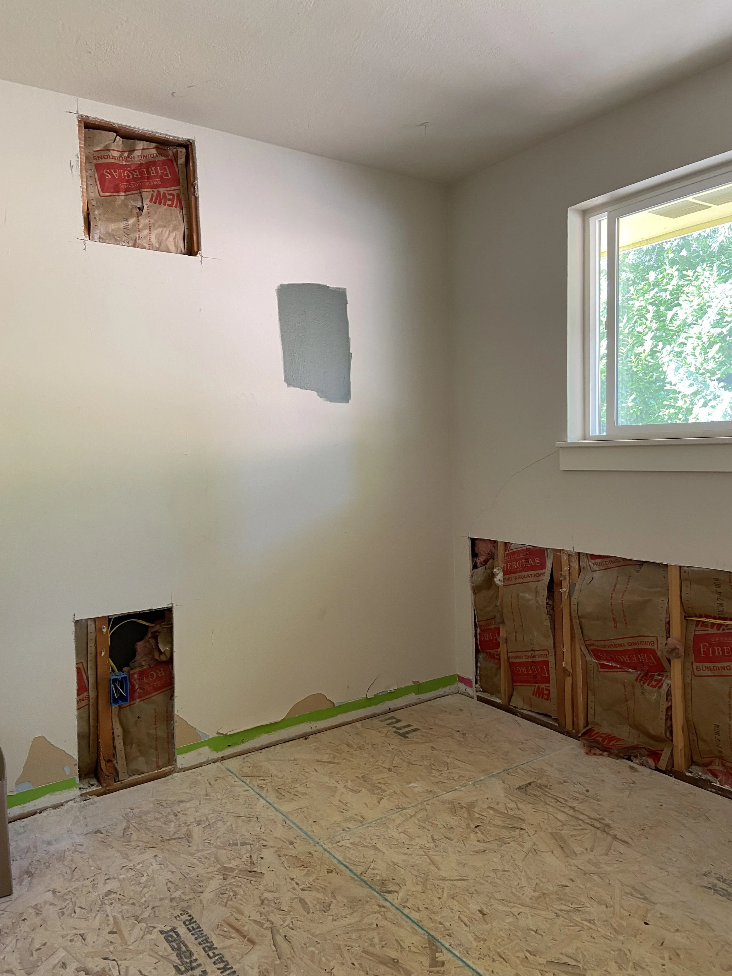 Before drywall repair in Redmond WA remodel showing wall damage and unfinished surfaces.