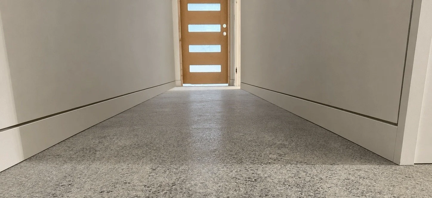Finished Redmond hallway with recessed baseboards and continuous shadow-reveal detailing.