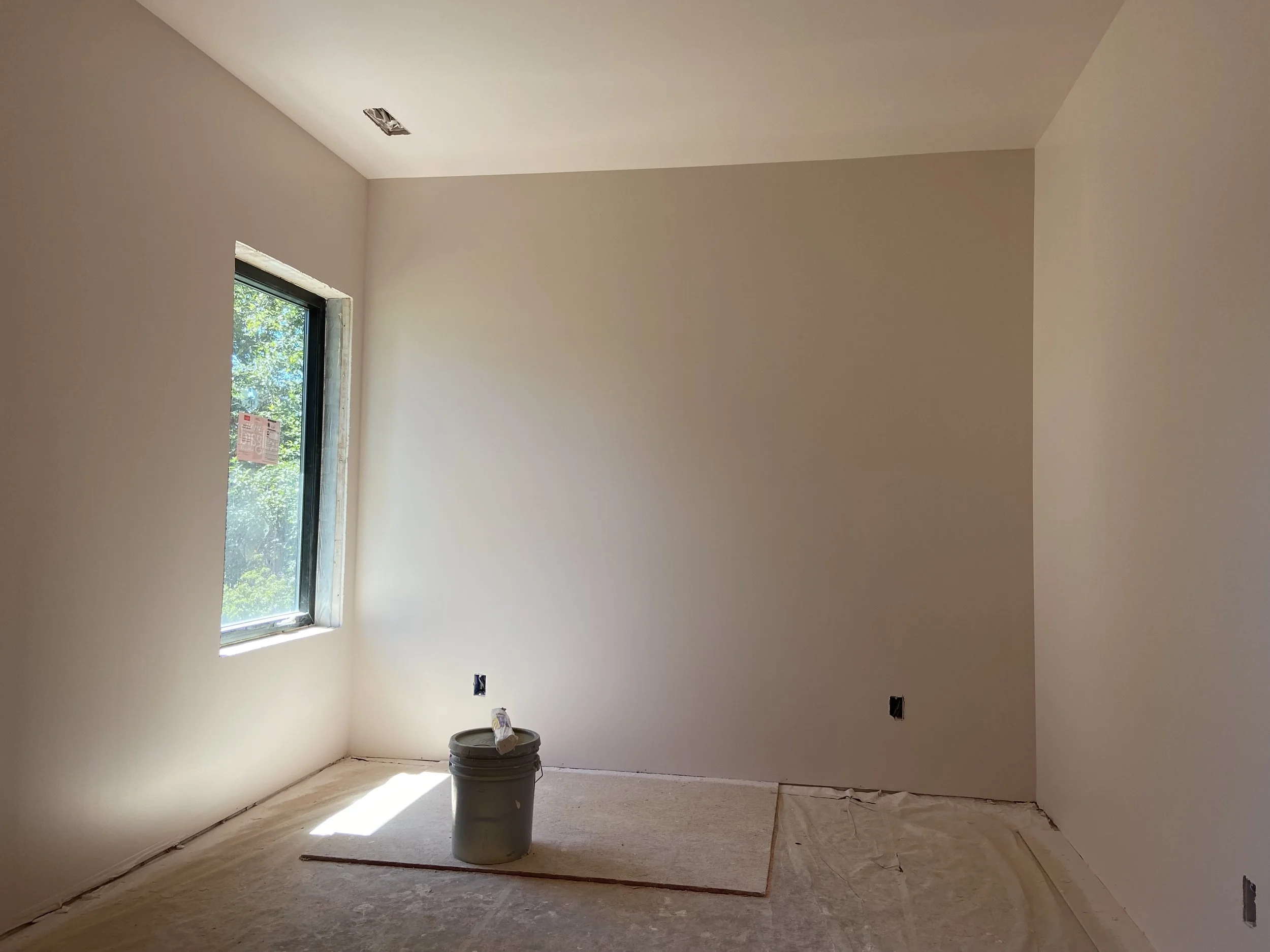 Finished Seattle basement with drywall installation, smooth wall finishing, primer, and interior painting