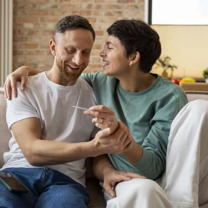 happy couple looking at pregnancy test