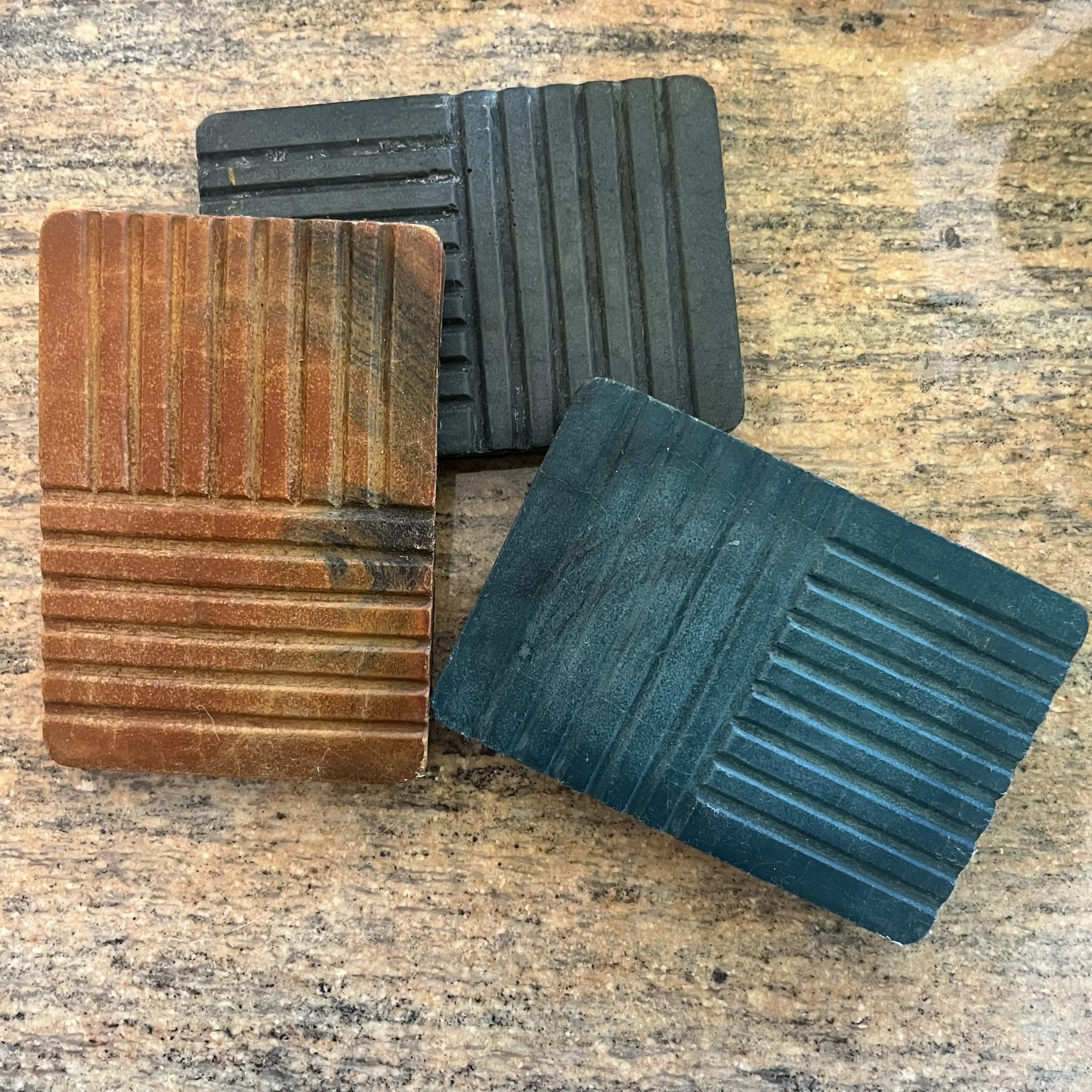 three concrete strata soap dishes.jpeg