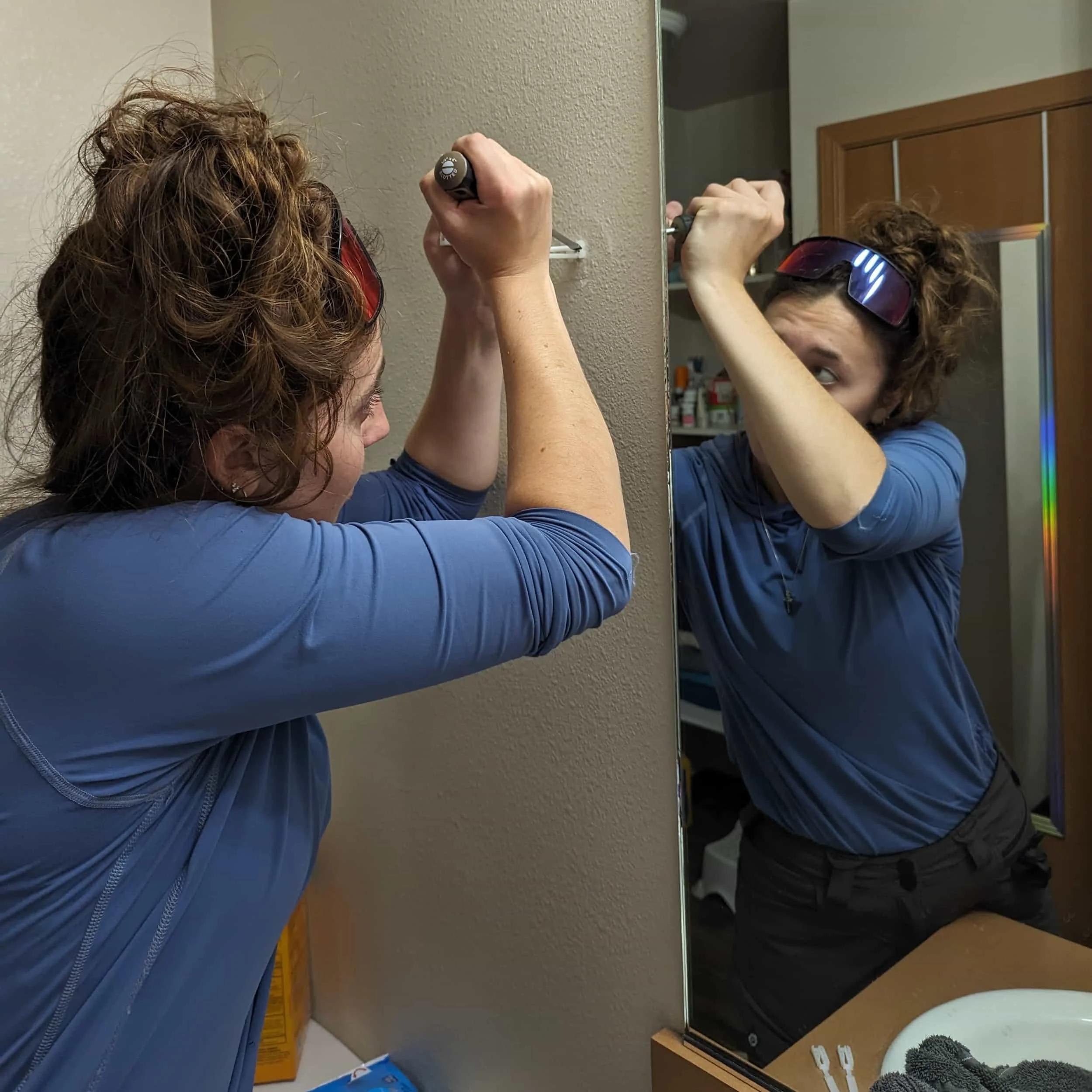 woman replacing a towel bar