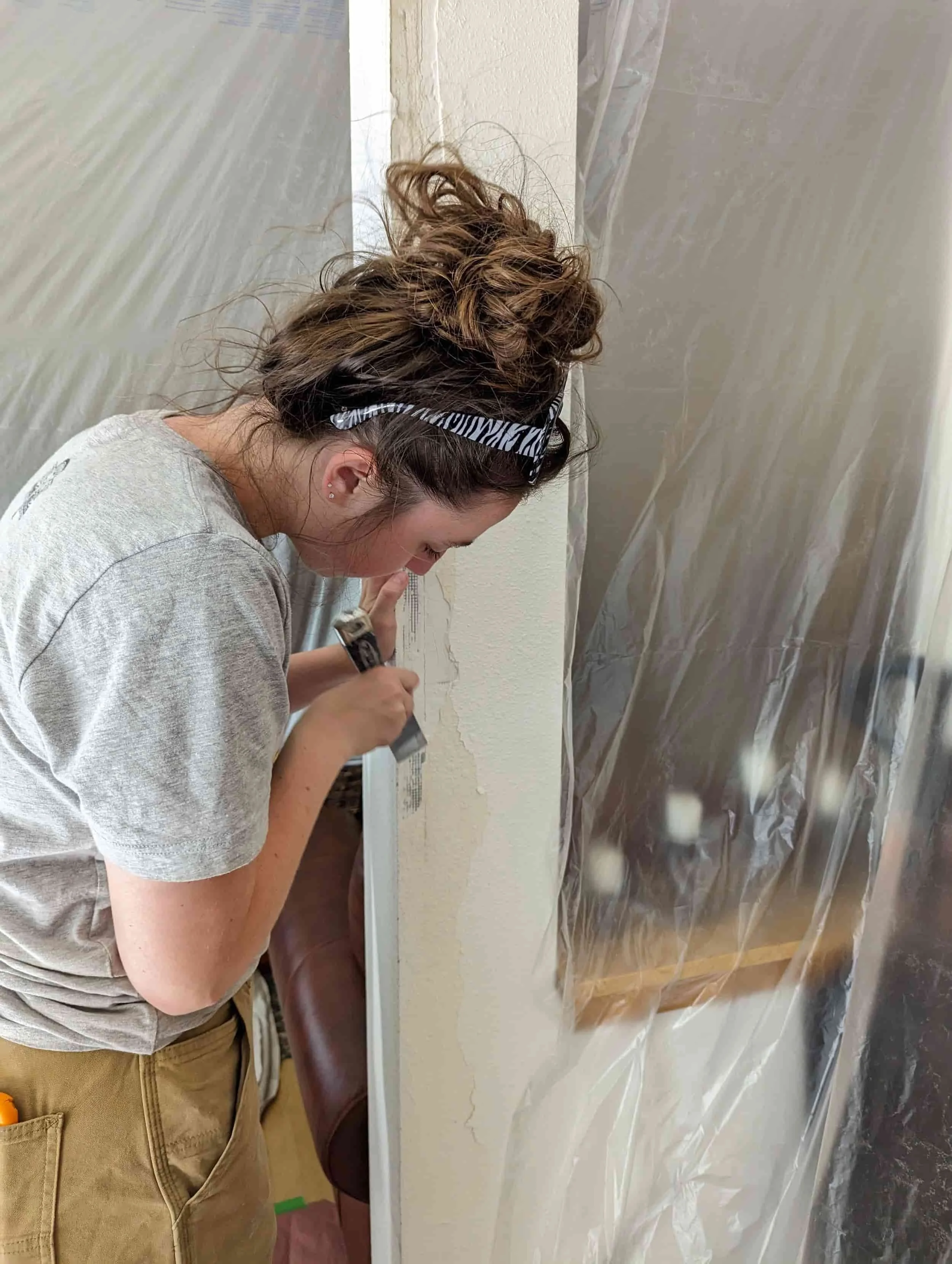 woman repairing drywall