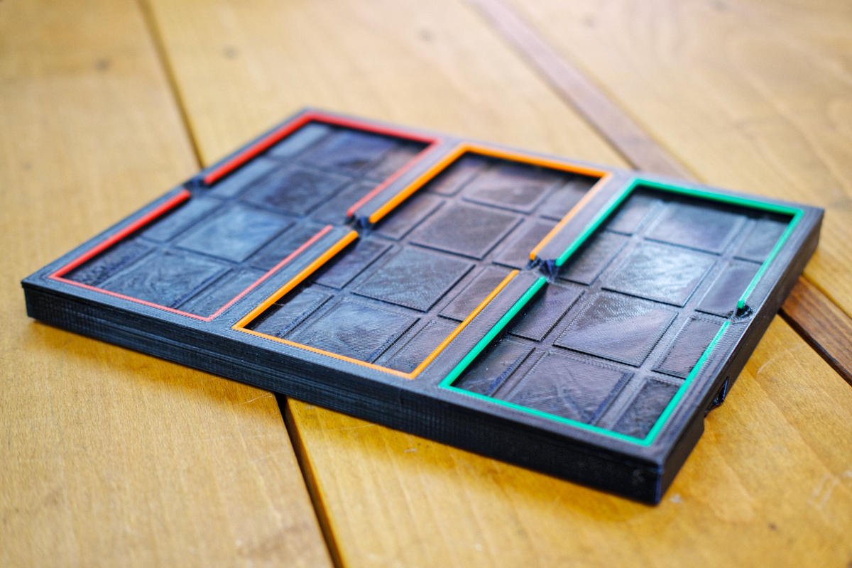 PETG 3D printed base to hold diamond sharpening stones. Grooves are printed in the bottom of the recesses.