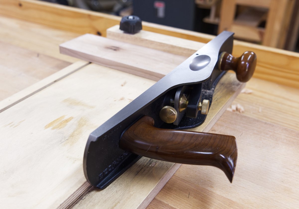 A Veritas Low Angle Jack hand plane lying on its side while being used to plane end grain on a shooting board.