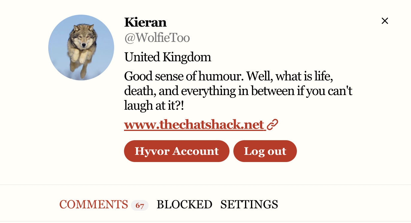A social media profile of Kieran with a profile picture of a wolf puppy against a blue background. The profile states Kieran is from the United Kingdom, and includes humorous text about life and death. There are buttons for 'Hyvor Account' and 'Log out,' along with links to www.thechatshack.net.