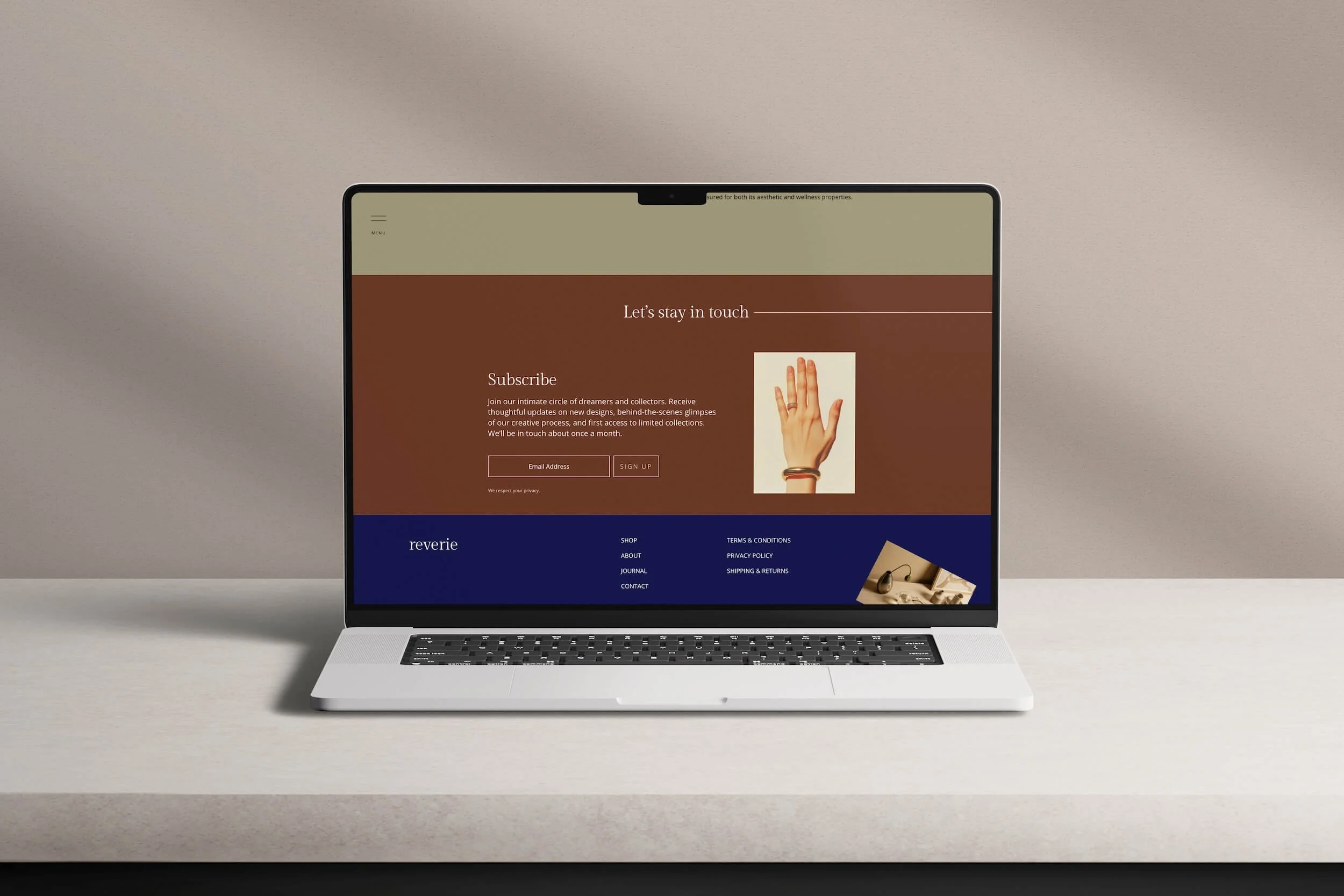 Laptop showing Reverie jewelry website newsletter signup section